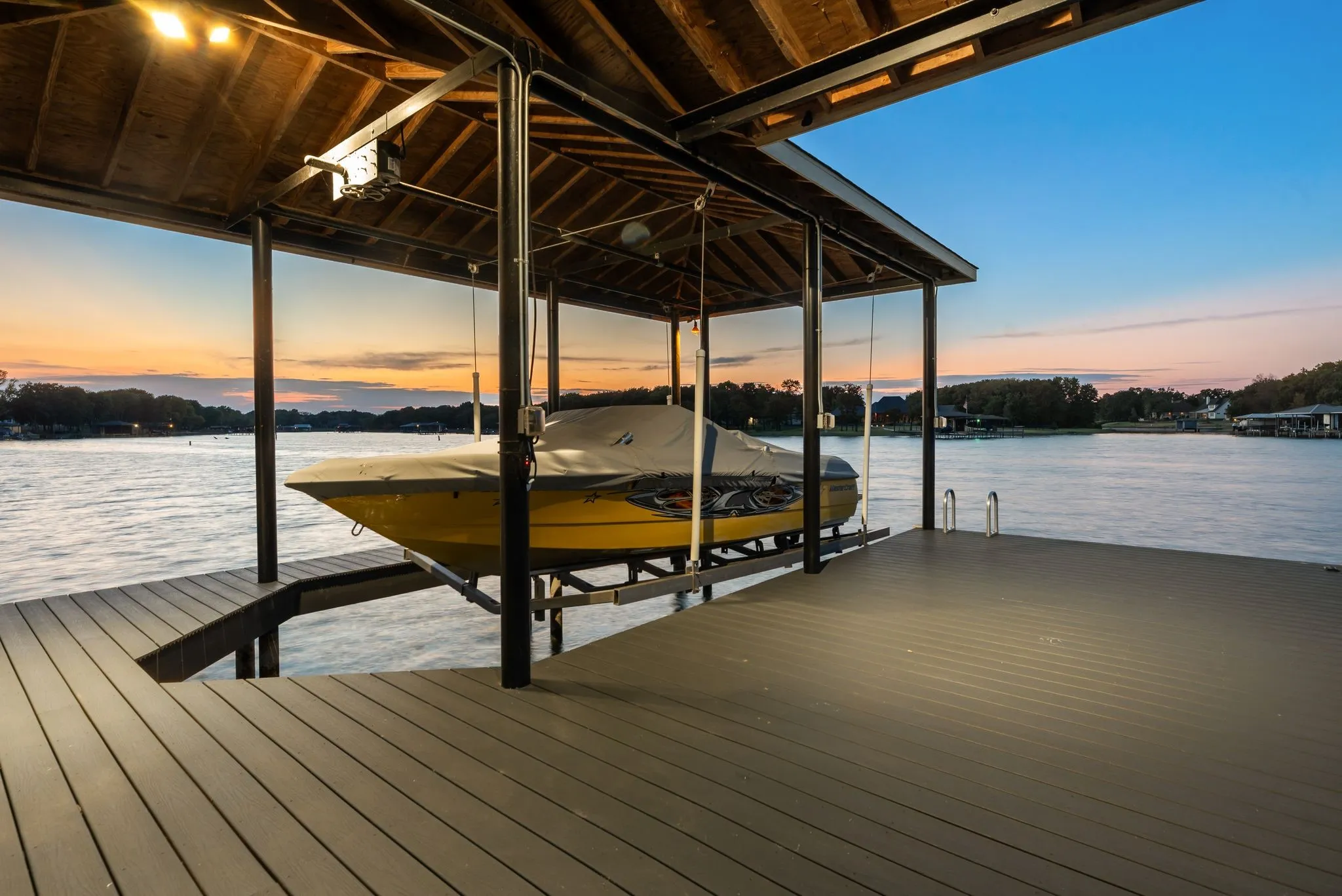 Private covered dock offers direct deep-water access and a front-row setting for boating, fishing, sunsets, and the Richland Chambers Lake lifestyle.