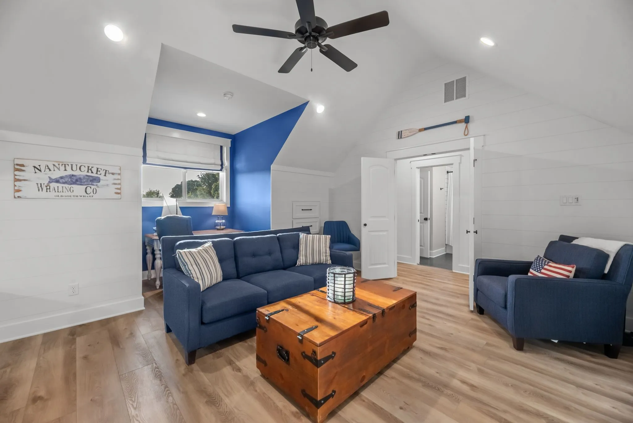 Upstairs bonus room combines built-in bunks with a separate lounge area, creating an ideal space for guests, kids, or weekend lake gatherings.