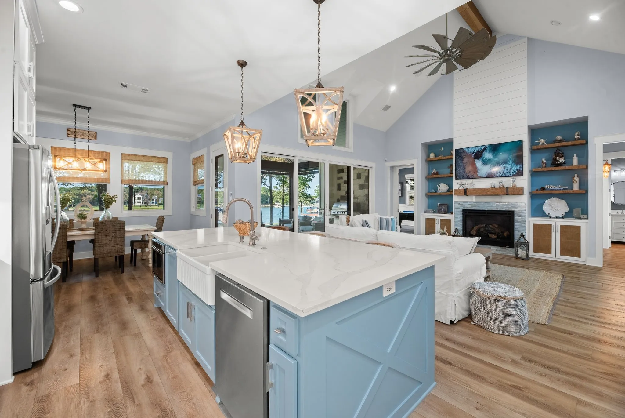 Spacious primary bedroom features peaceful backyard views, vaulted ceiling, wood-beam details, and direct access to the covered lakefront patio.