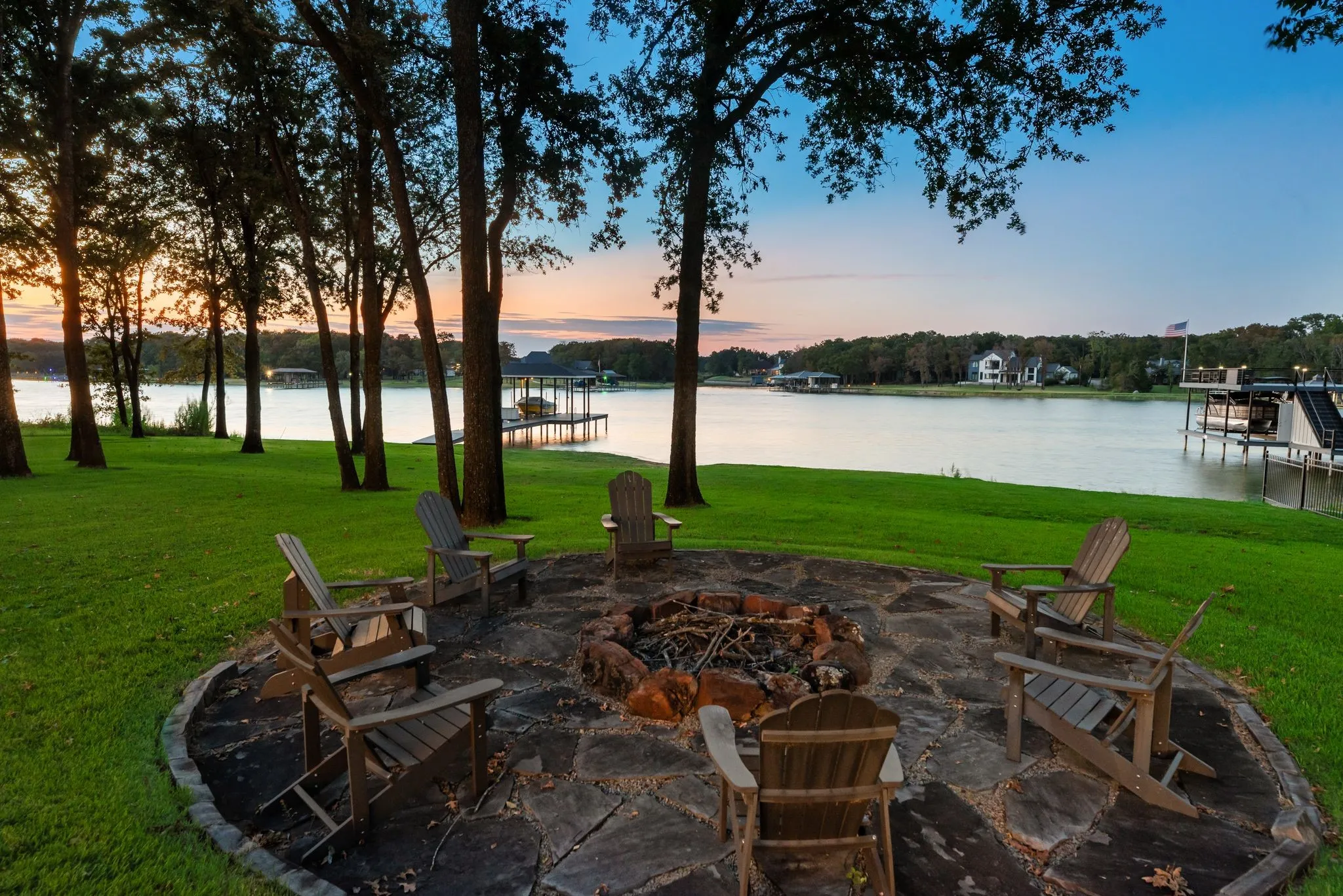 Lakefront fire pit surrounded by mature shade trees creates an inviting gathering spot for sunsets and evenings beside Richland Chambers Lake.