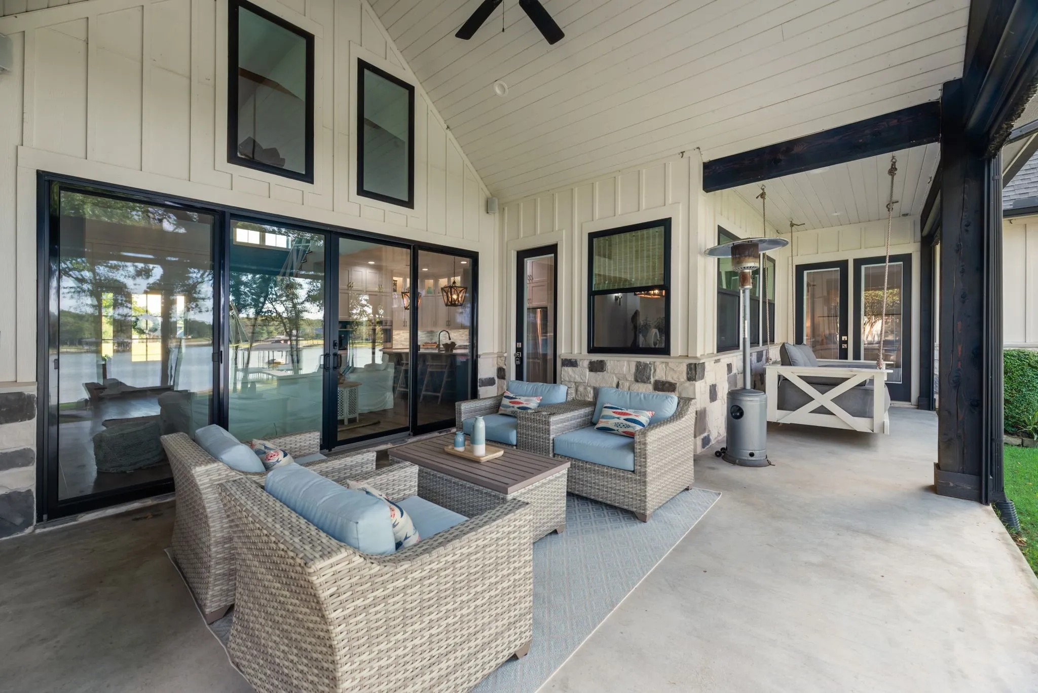 Expansive covered rear porch provides multiple seating areas and a comfortable transition between indoor living and the waterfront backyard.