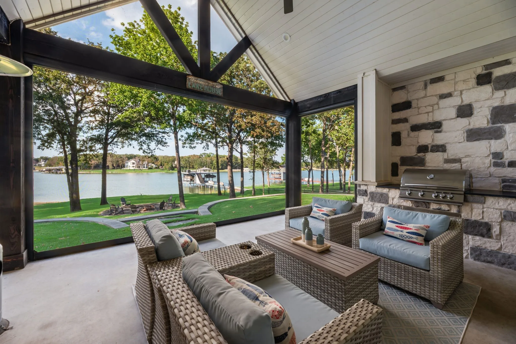 Covered lakefront patio with motorized screens creates an exceptional outdoor living and entertaining space overlooking Richland Chambers Lake.