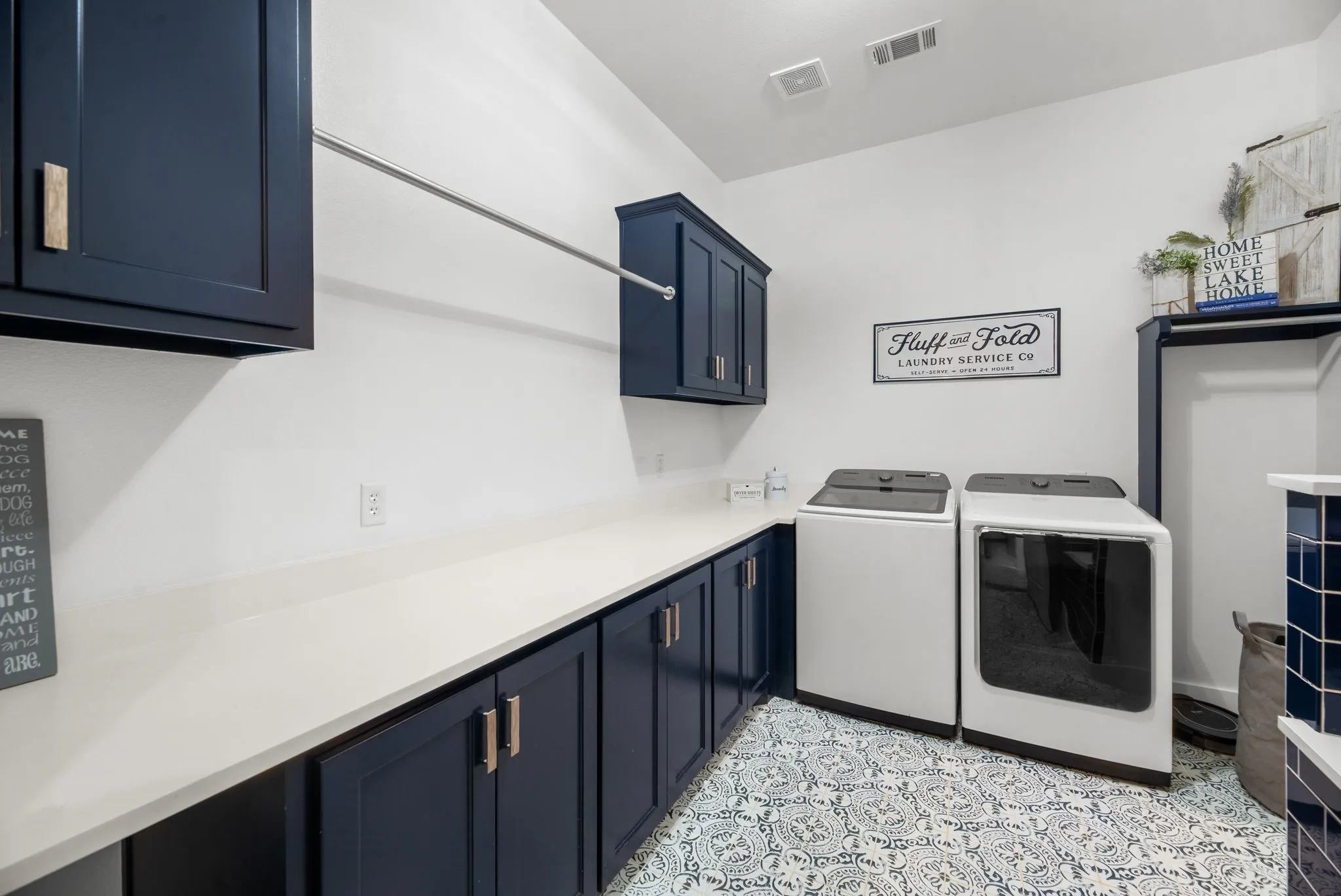 Large laundry room features extensive cabinetry, generous counter space, and full-size washer and dryer accommodations.