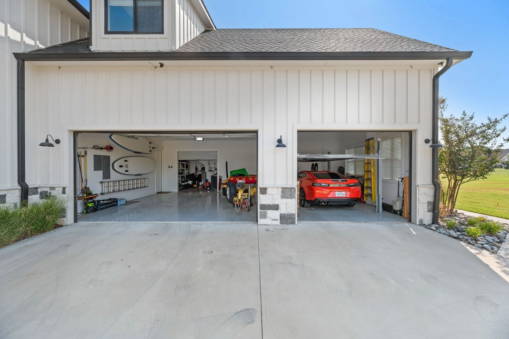 Oversized three-car garage offers extensive parking, storage, workshop space, and convenient room for lake-life equipment.