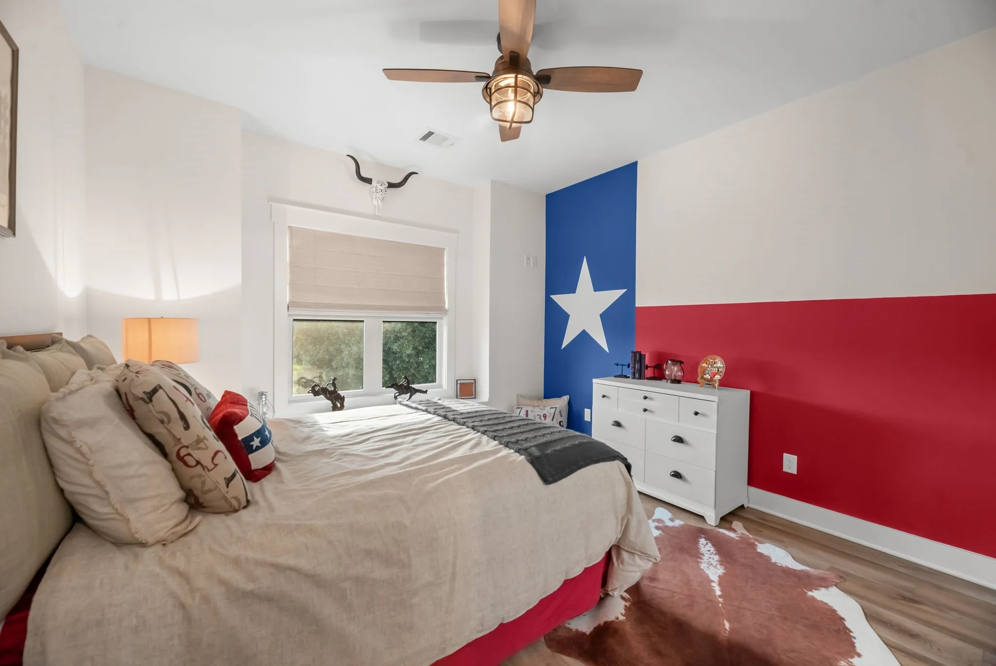 Comfortable secondary bedroom features warm natural light, hard-surface flooring, and generous proportions.