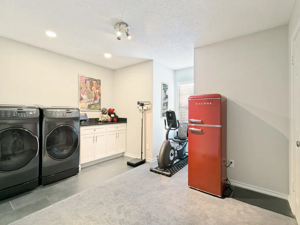utility room - was 4th bedroom converted to large utility room, other washer & dryer connections downstairs in hall leading to garage  behind cabinets