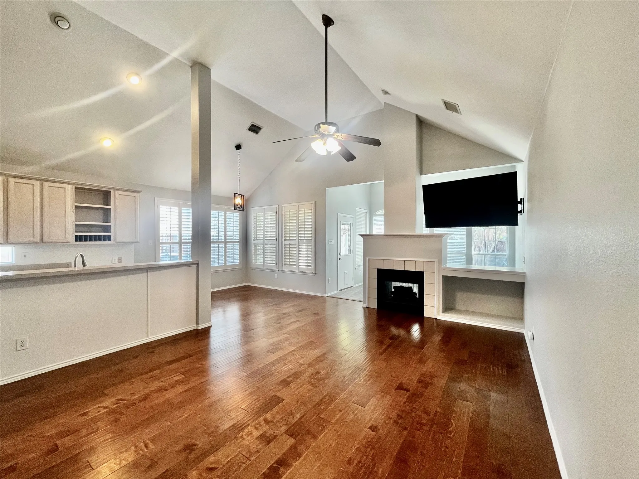 Big family room with engineered hardwoods. TV stays!