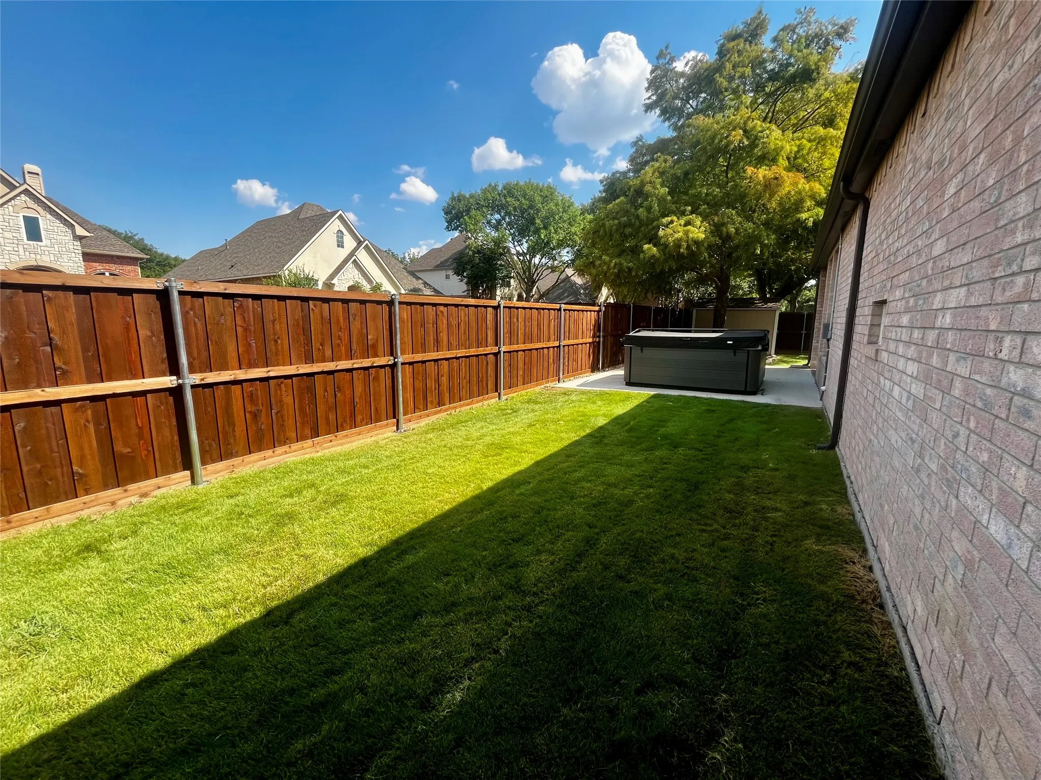 Side yard wraps to back yard.
