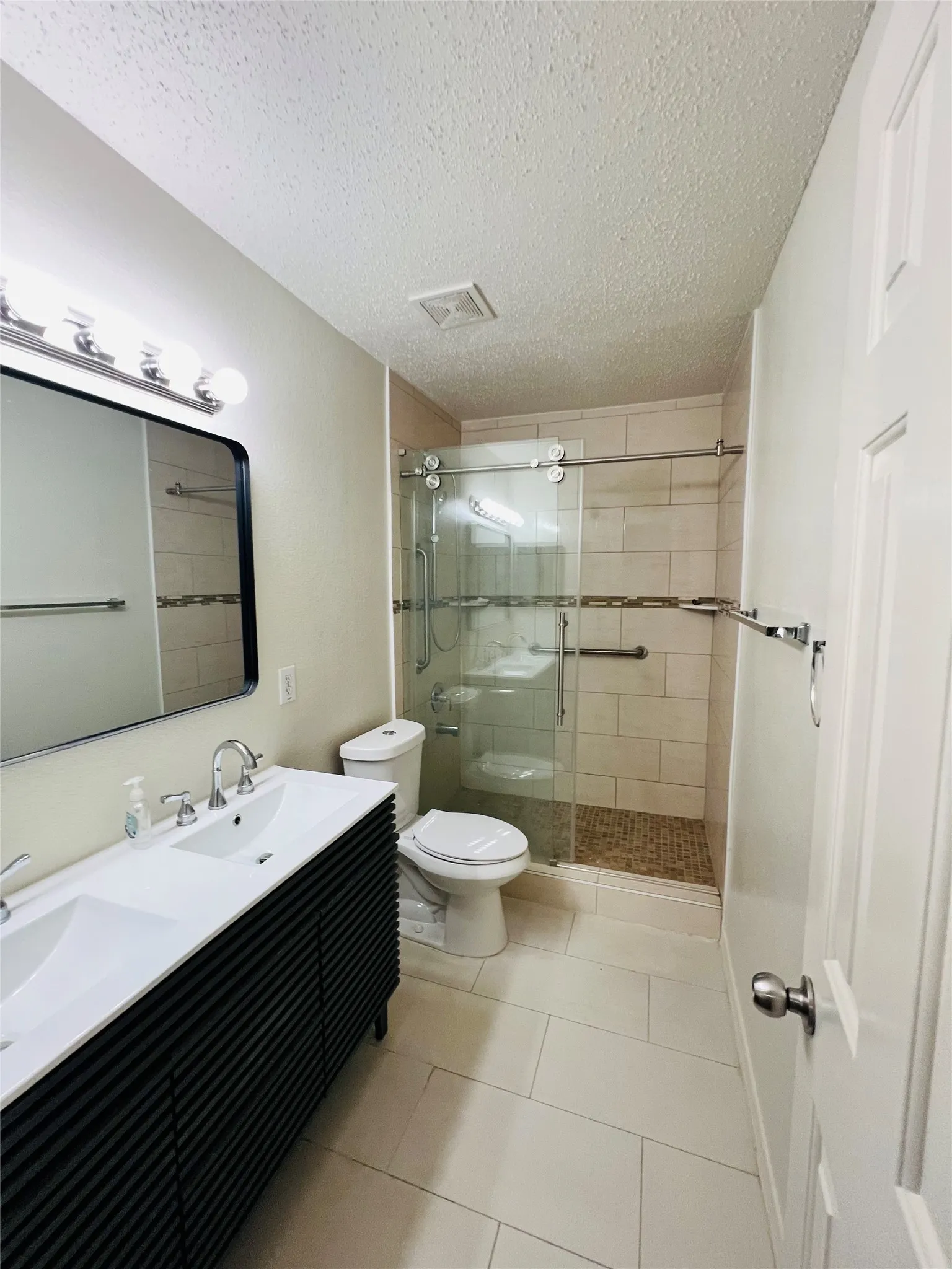 Dual sink vanity with dark fluted cabinetry and chrome fixtures