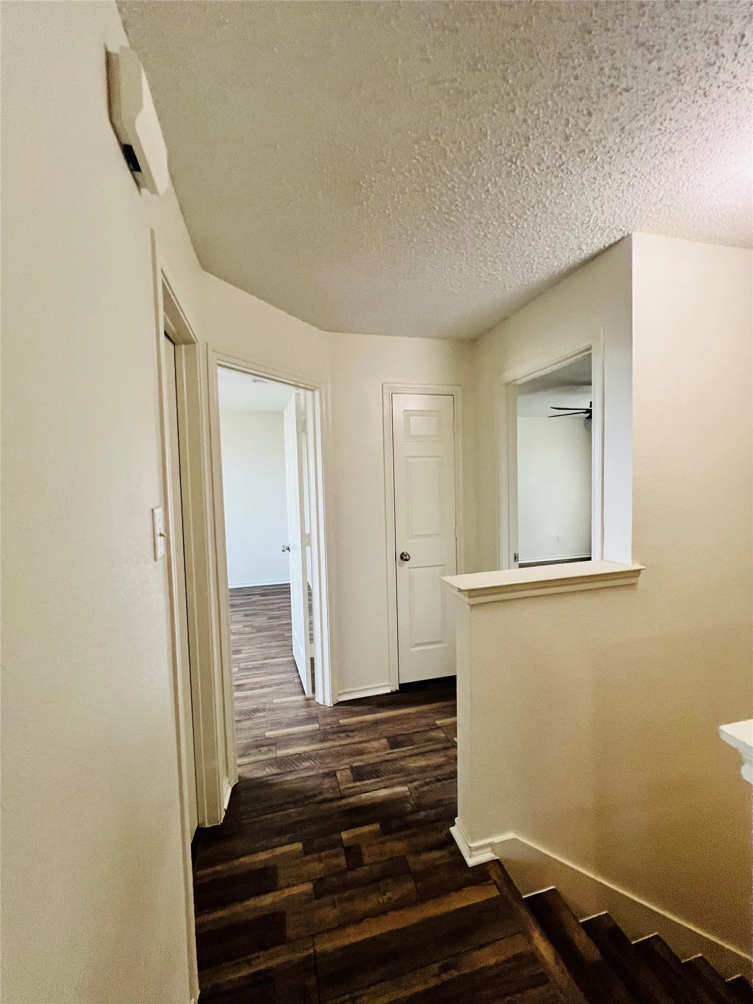 Wood-finish flooring throughout, white interior doors, and a neutral color palette