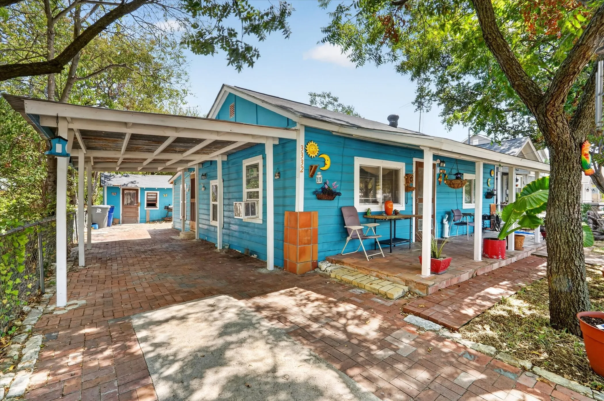 Turquoise exterior siding with a covered carport