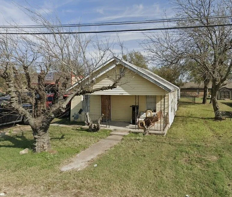 Front exterior with horizontal siding, covered porch, and a concrete walkway