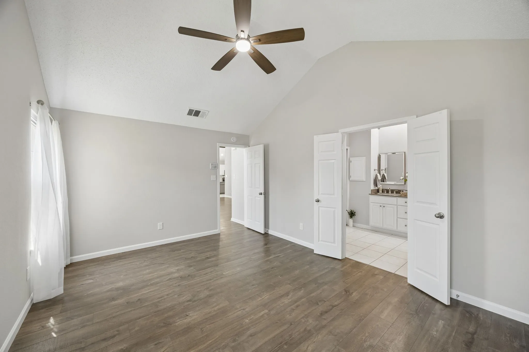 This view of the primary suite shows the ensuite bath