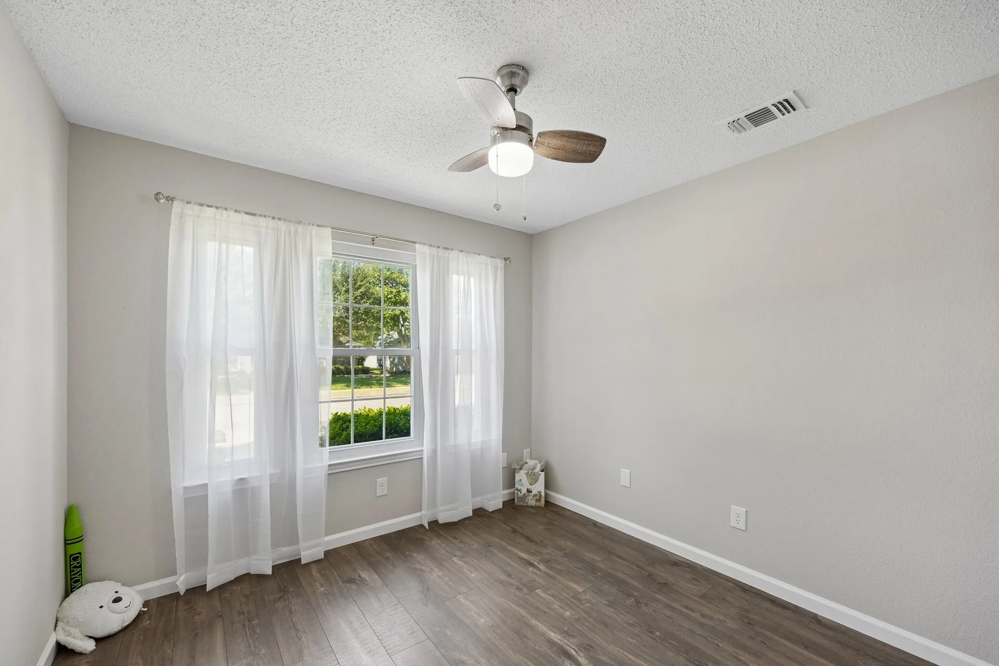 This is the first of the secondary bedrooms - lovely flooring and NEW ceiling fan!