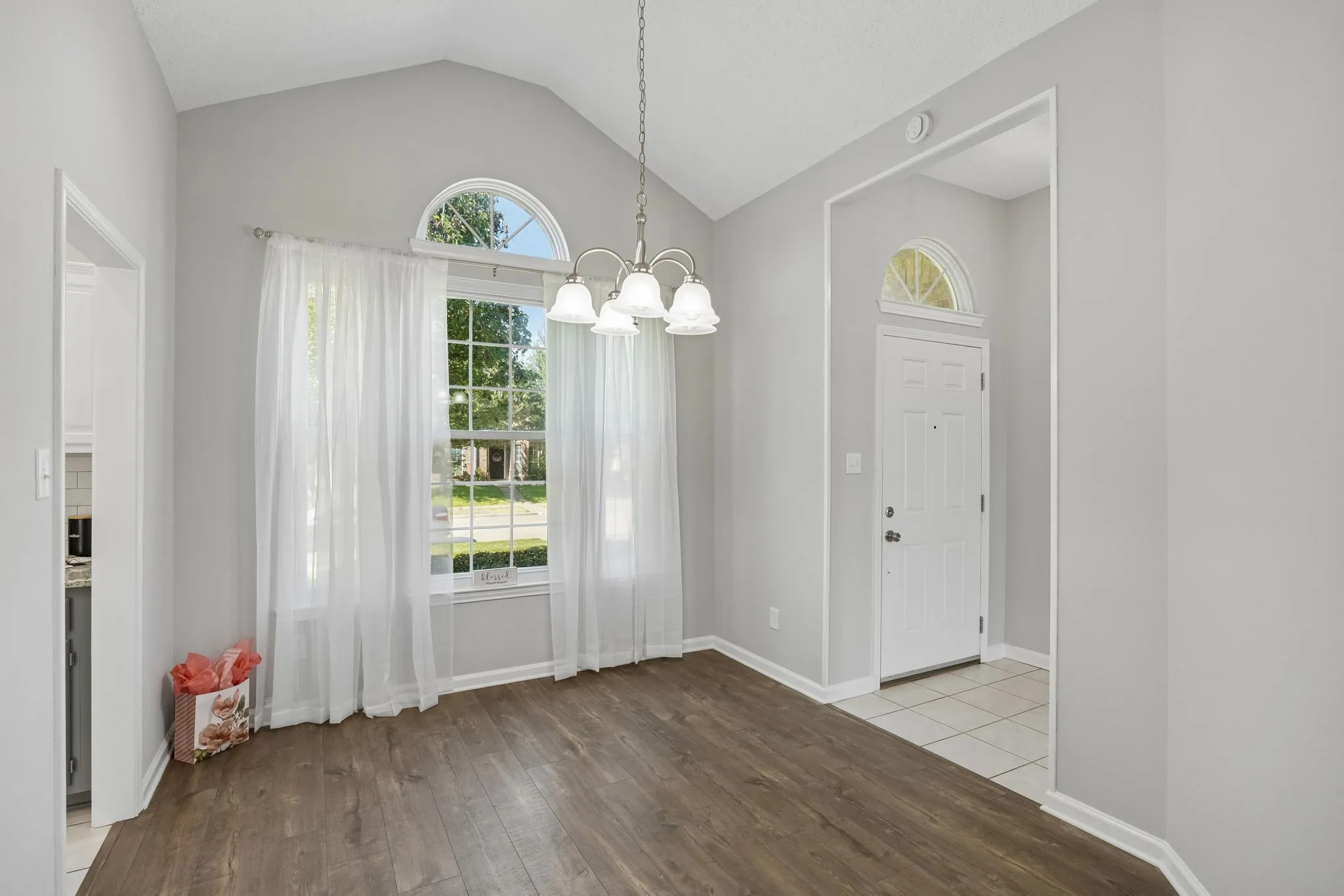 The formal dining room is enhanced by striking front windows, offering an elegant and versatile space.