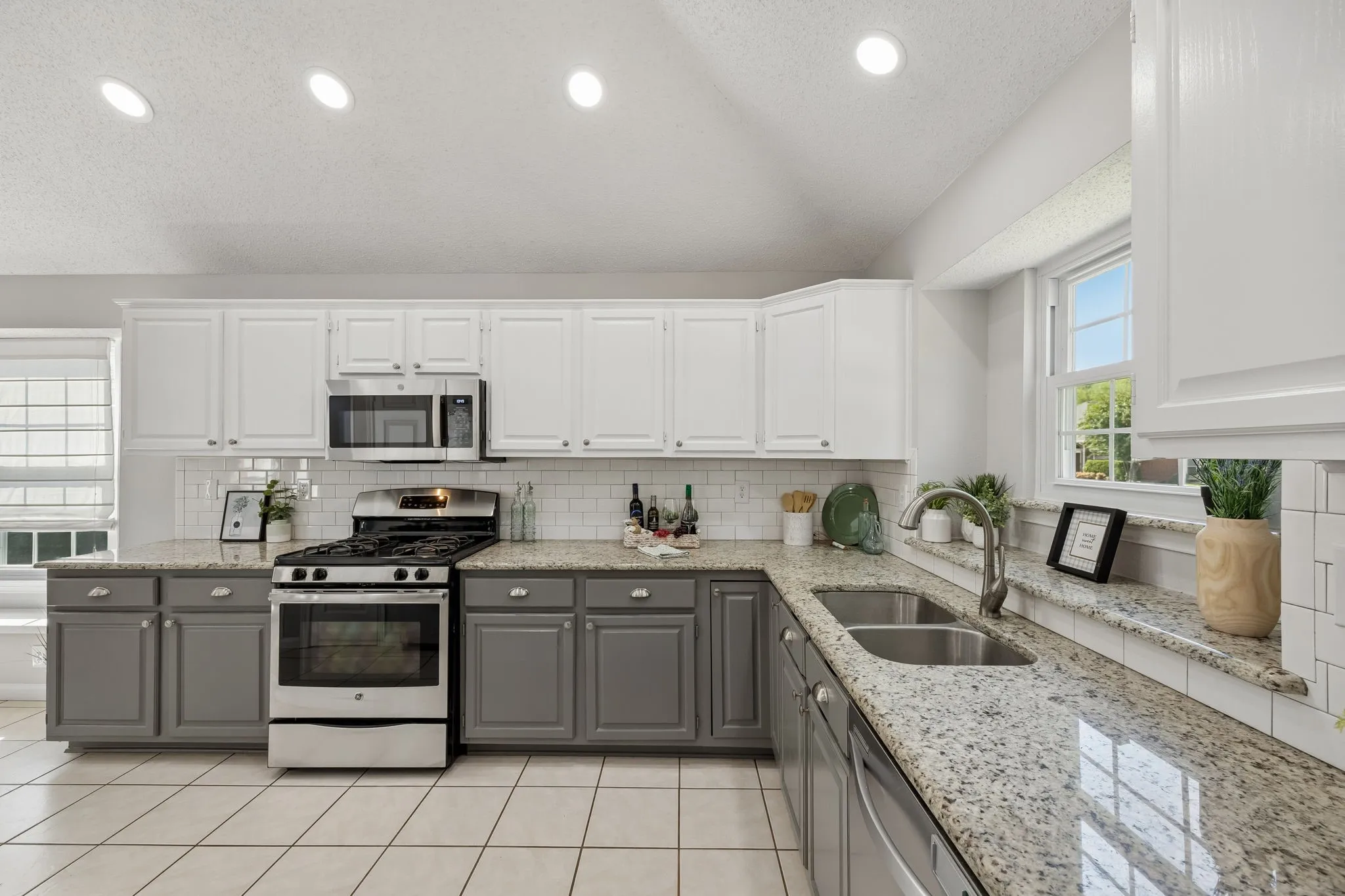 Freshly Painted top and bottom cabinets really show off how grand this striking kitchen is - gorgeous granite counters, undermount sink and SS appliances add to the "Gourmet'' of this inviting space!