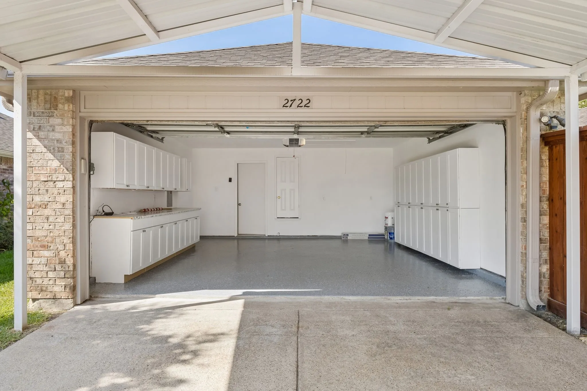 This amazing garage space features extensive custom-style cabinetry, expansive workspace, and a professionally painted Epoxy floor—combining organization with impressive functionality.extensive custom-style cabinetry, expansive work surfaces, and a newly finished Epoxy painted floor—combining organization with impressive functionality!