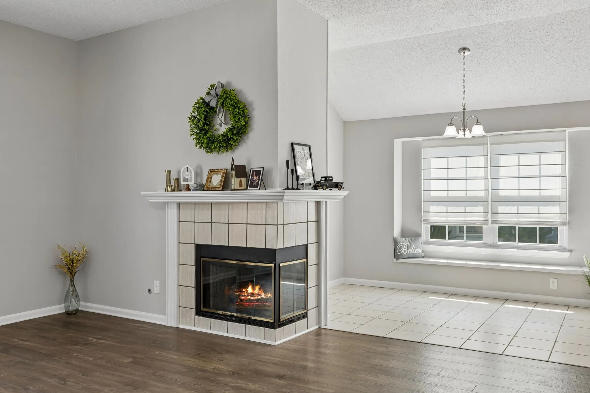 A charming corner fireplace adds warmth and architectural interest to the living space, while the light-filled breakfast nook offers an inviting place for morning coffee or casual meals.