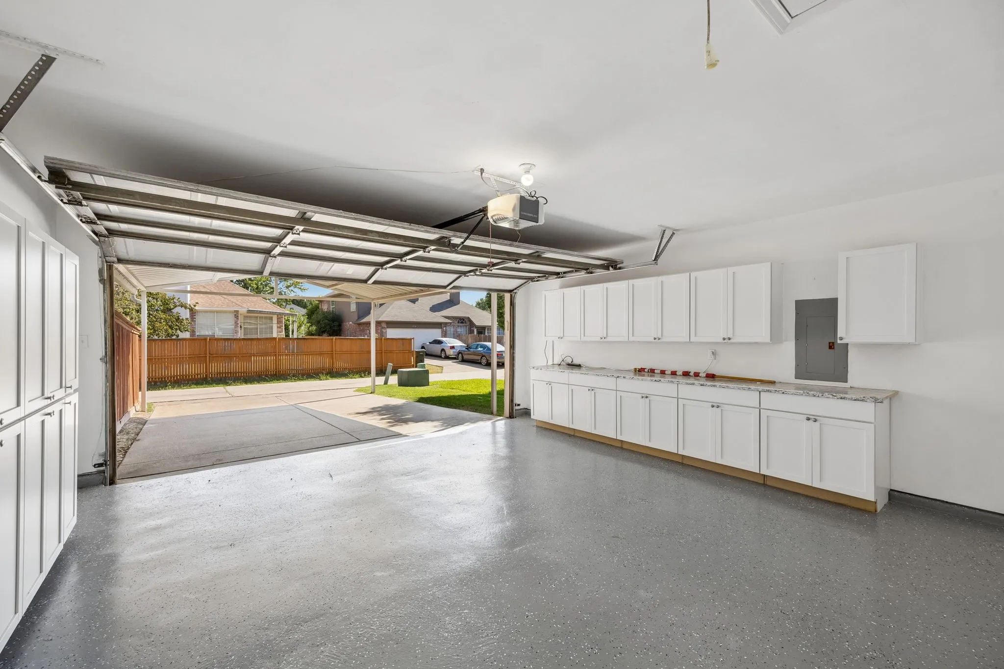 This photo shows just how amazing the garage cabinets and NEW Epoxy Flooring looks!