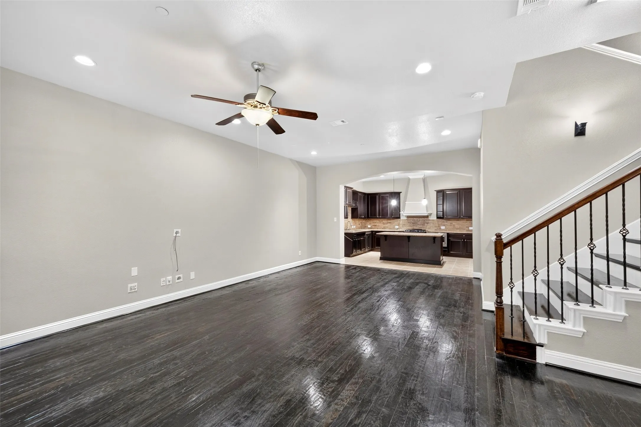 Hardwood flooring, recessed lighting, and a ceiling fan