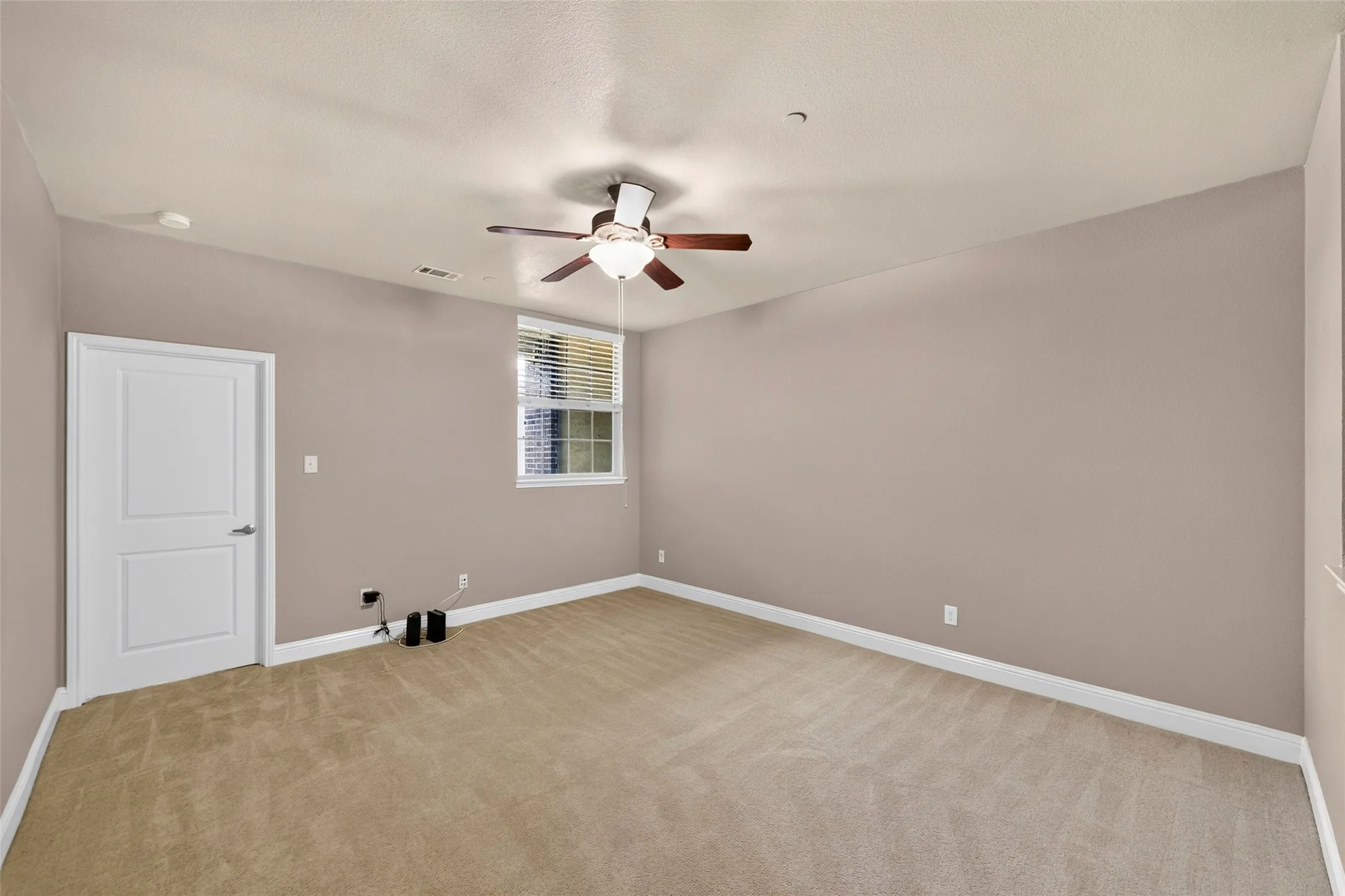 Neutral-toned walls complement the light beige carpeting