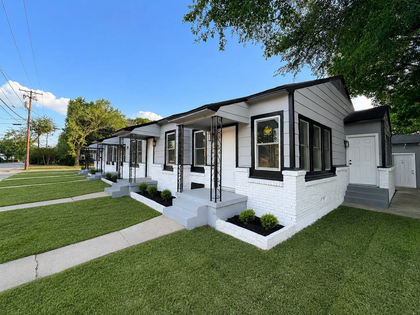 Modern multi-unit property with a white brick and gray siding exterior