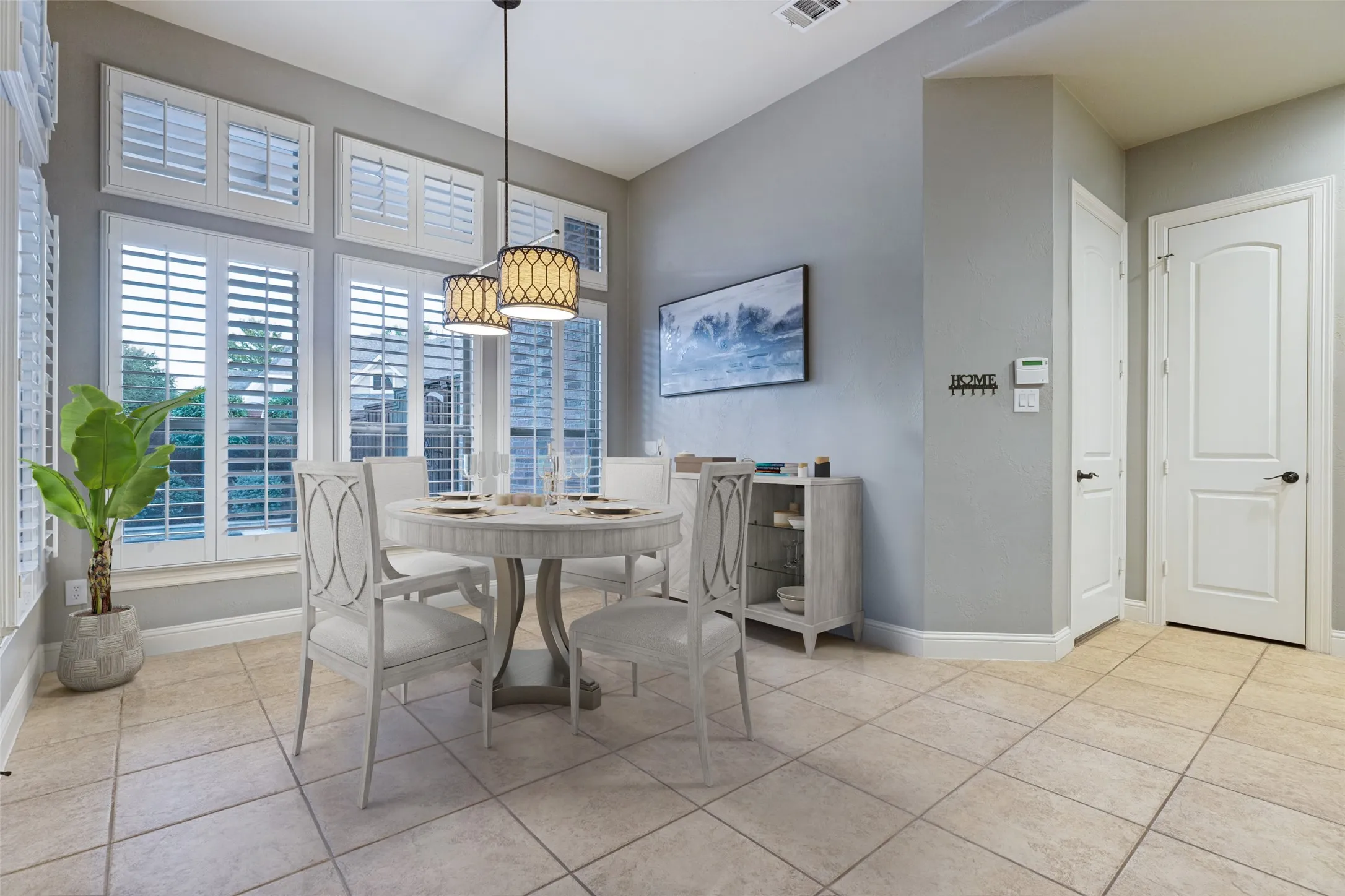 Tiled flooring throughout, high ceilings, multiple windows with plantation shutters, recessed lighting, and a pendant light fixture
