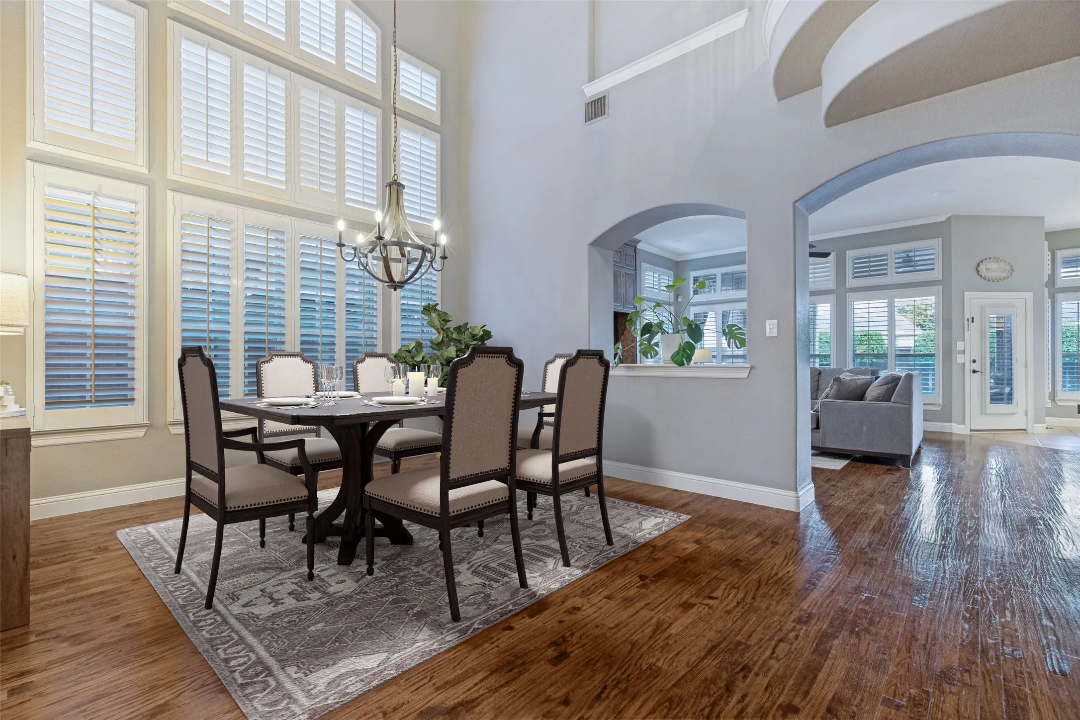 Two-story vaulted ceilings, wood-finish flooring, plantation shutters, and arched doorways