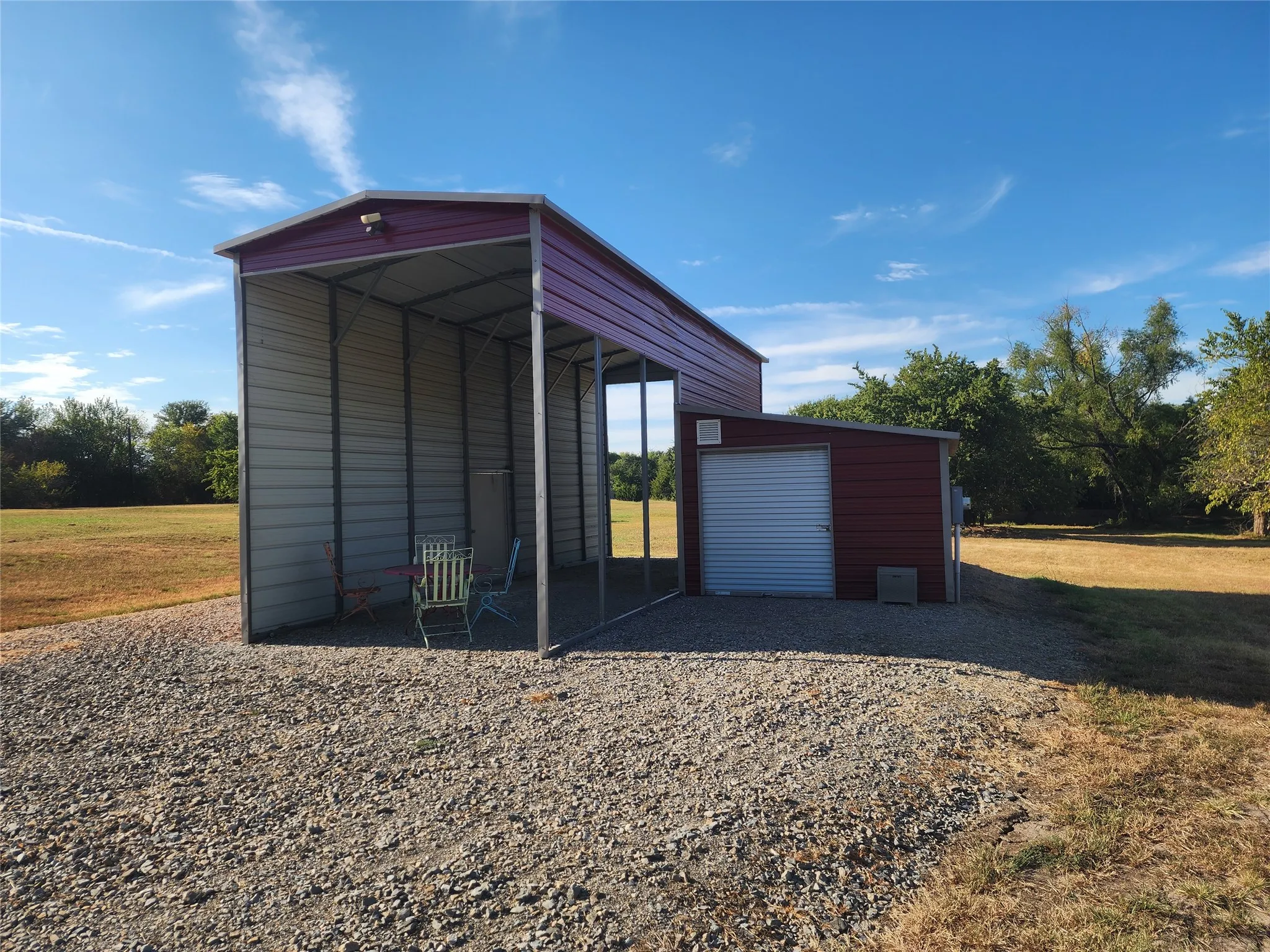 Freestanding carport structure with corrugated metal roofing