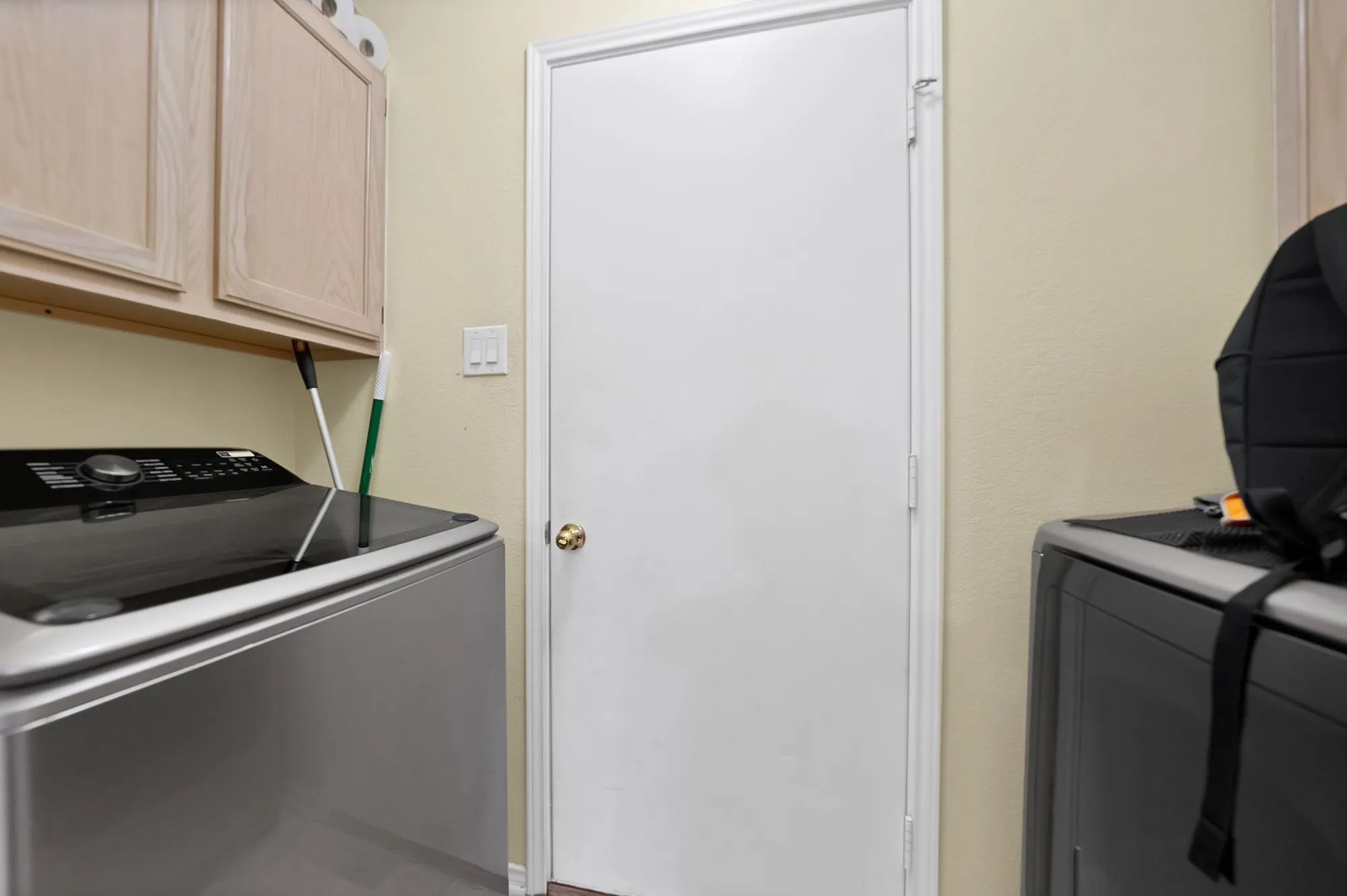 Built-in upper cabinetry with light wood-finish