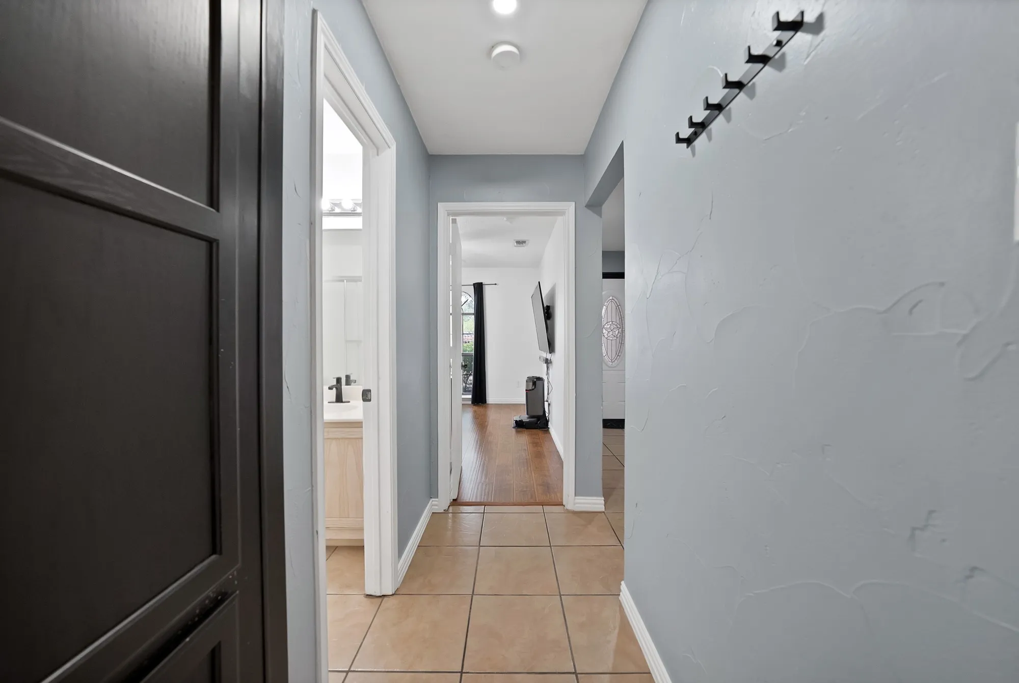 Tile flooring and light-toned walls with an arched doorway