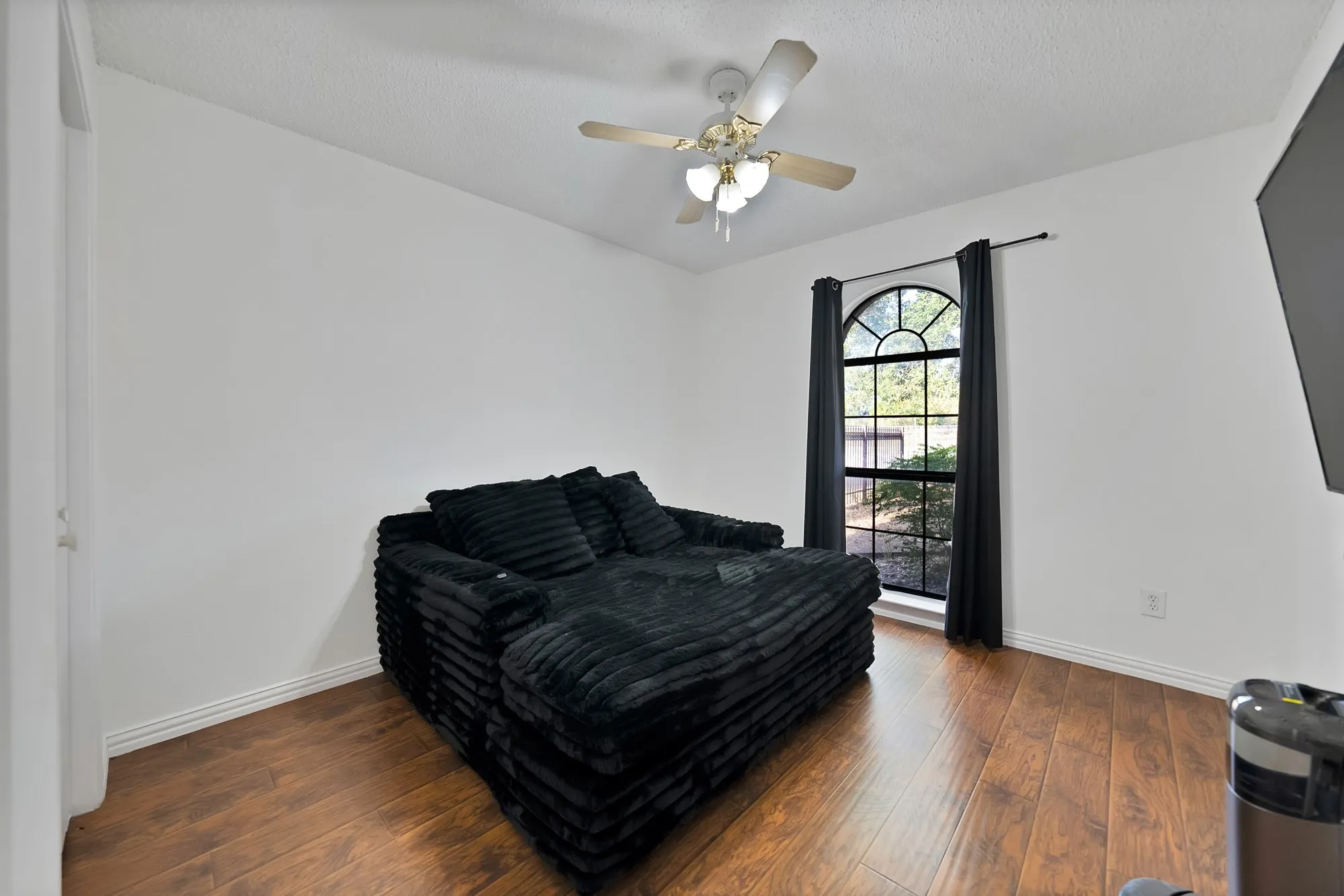 Wood-finish flooring with white baseboards