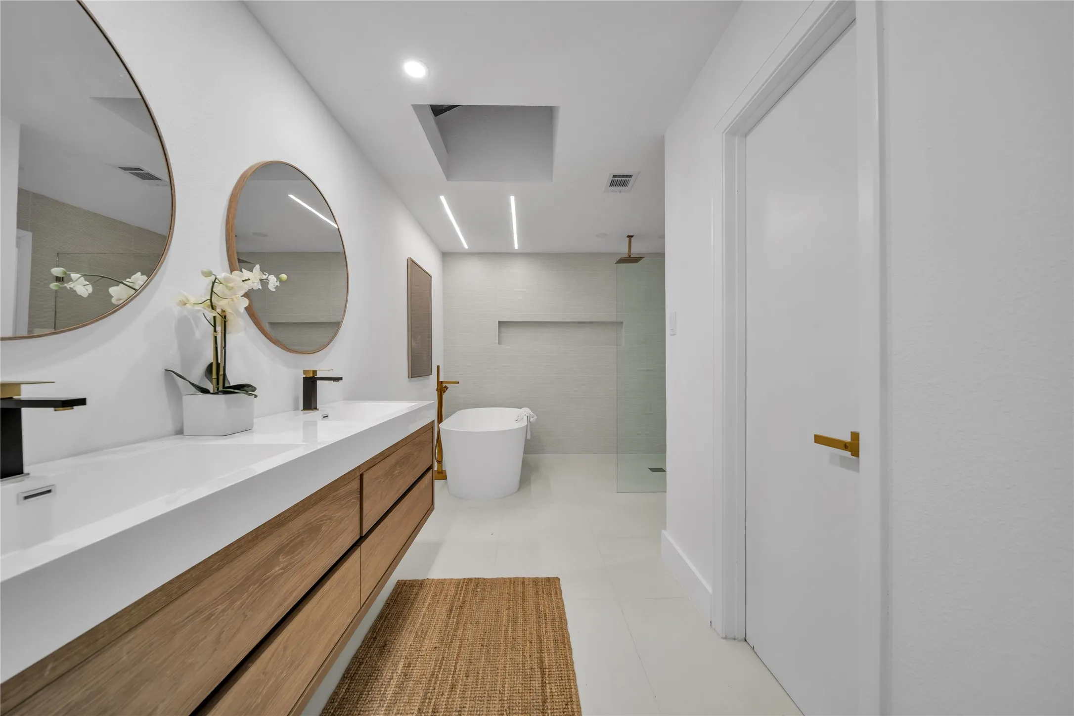 Full bathroom with a freestanding tub, a tile shower, and a sink
