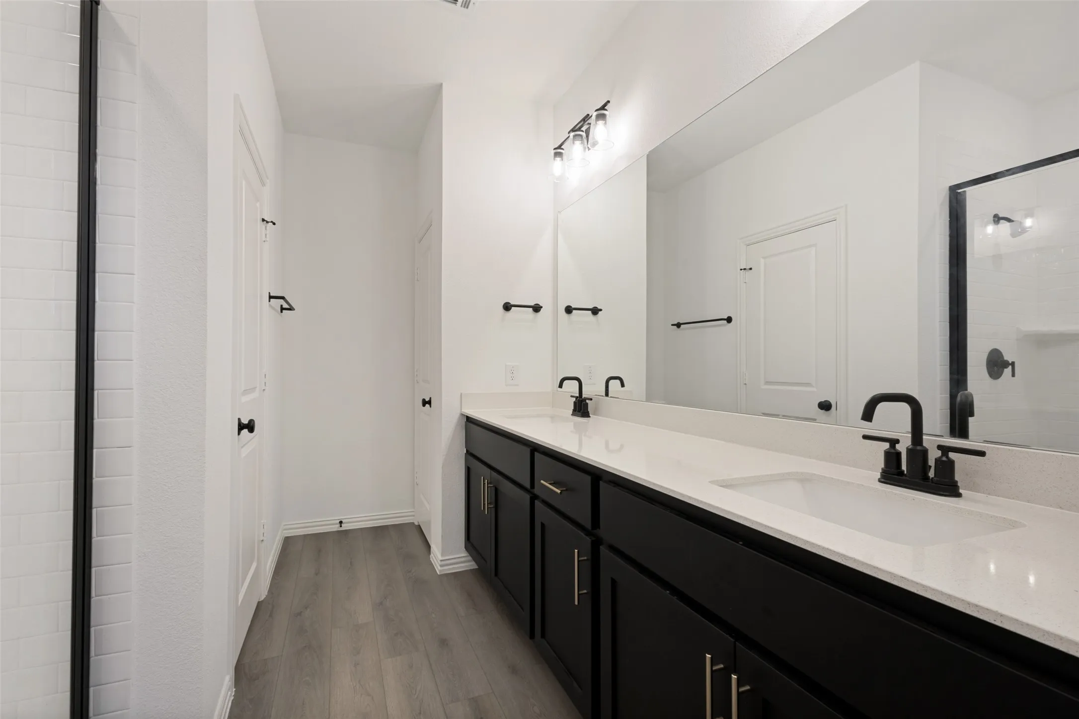Dual vanity with white countertops and undermount sinks