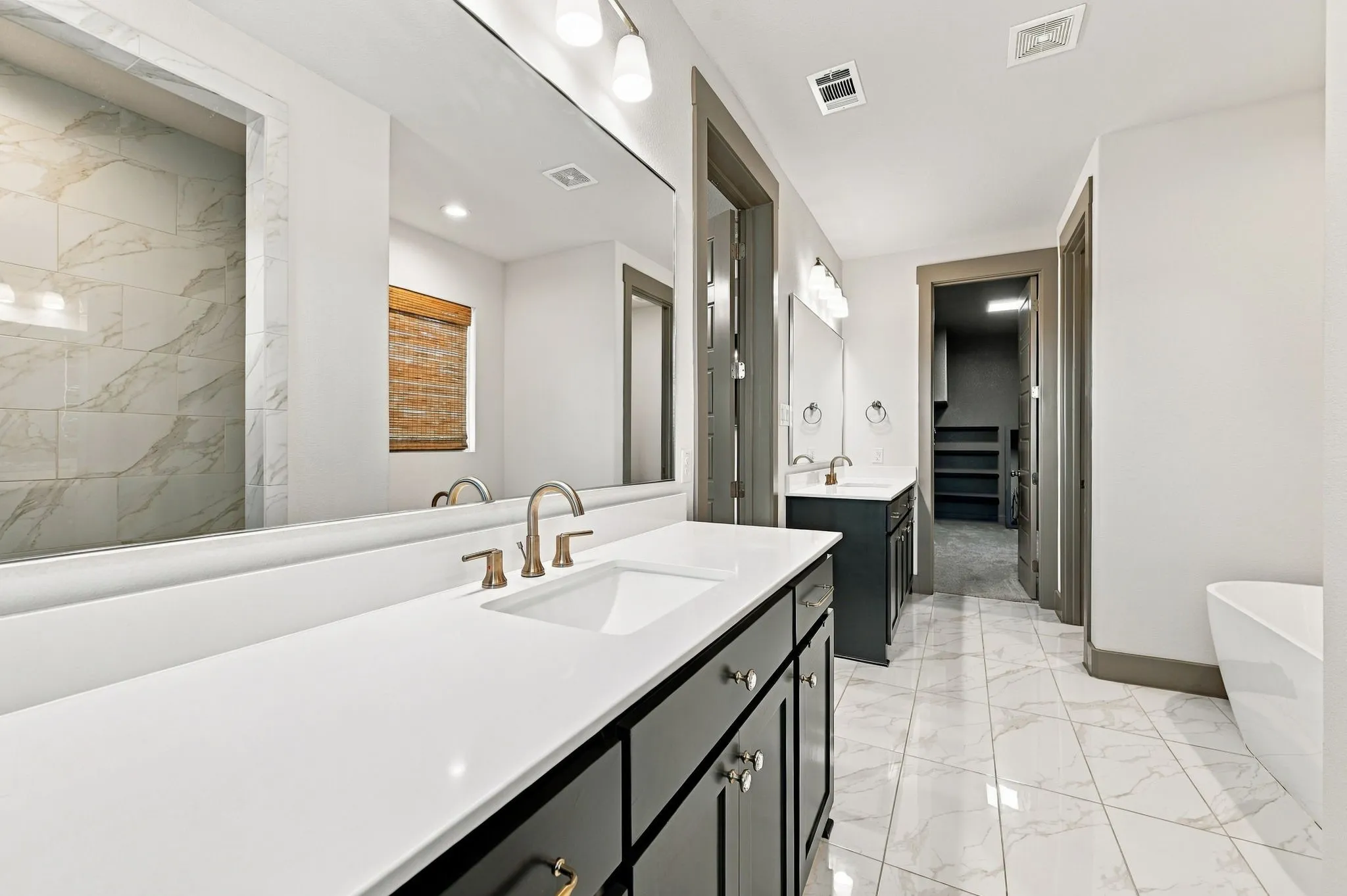 Dual vanity with white countertops and undermount sinks