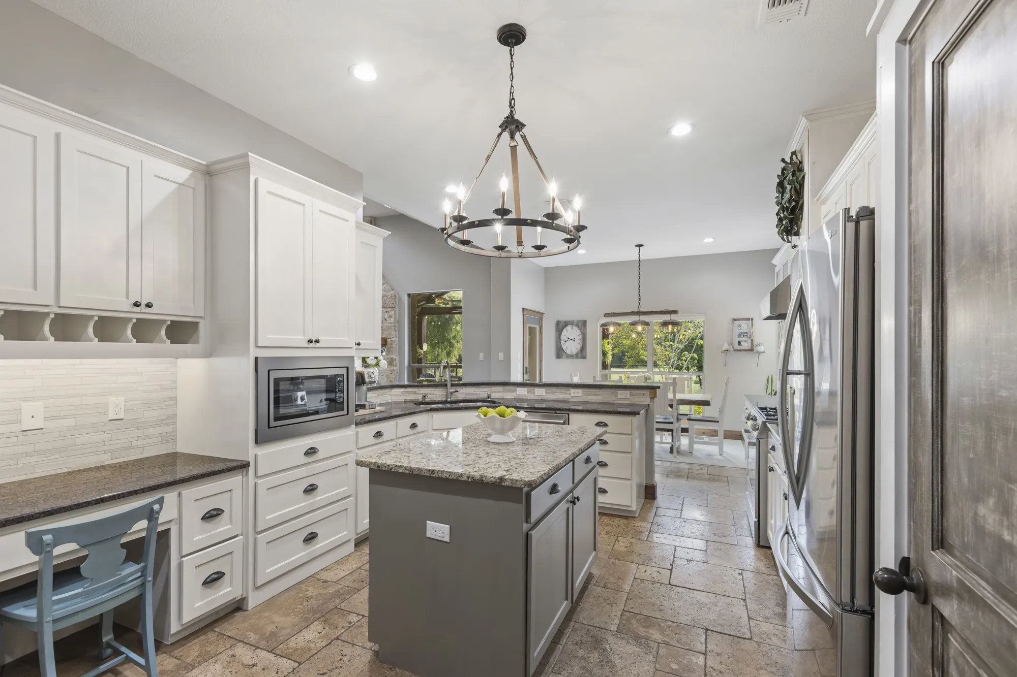 Well-appointed kitchen featuring granite countertops, a central island, recessed lighting, and integrated stainless steel appliances