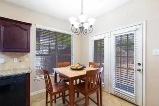 breakfast space with a chandelier and light tile patterned floors