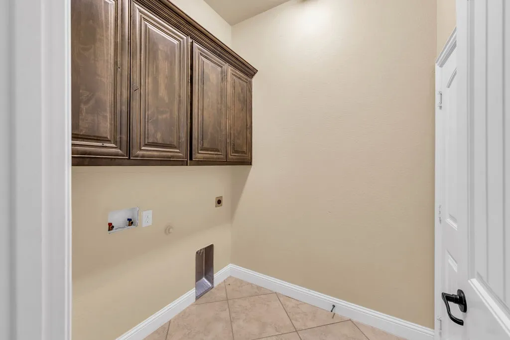 Built-in cabinetry, tile flooring, and light-toned walls