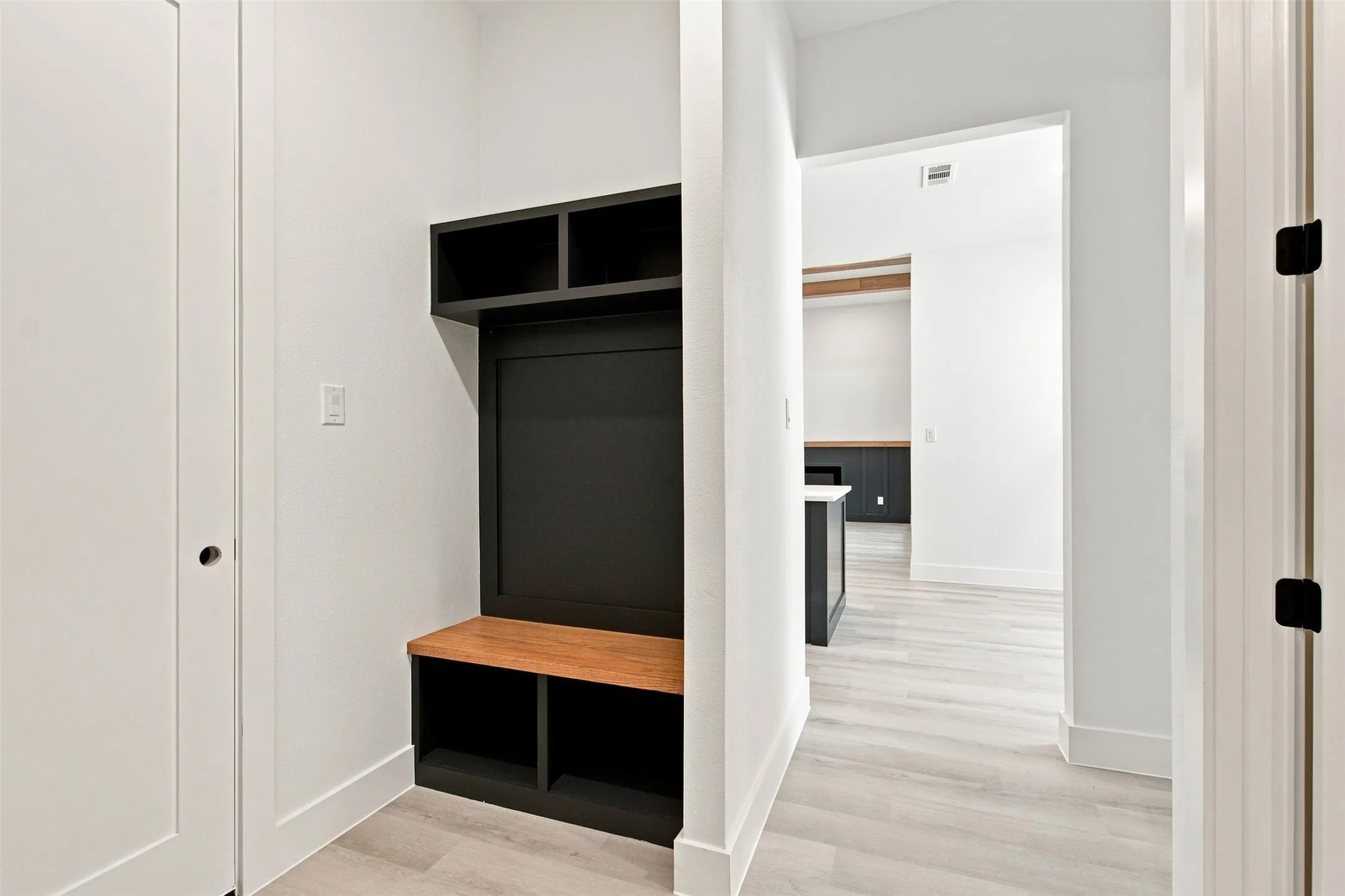 Built-in storage bench with overhead shelving and wood-finish seating
