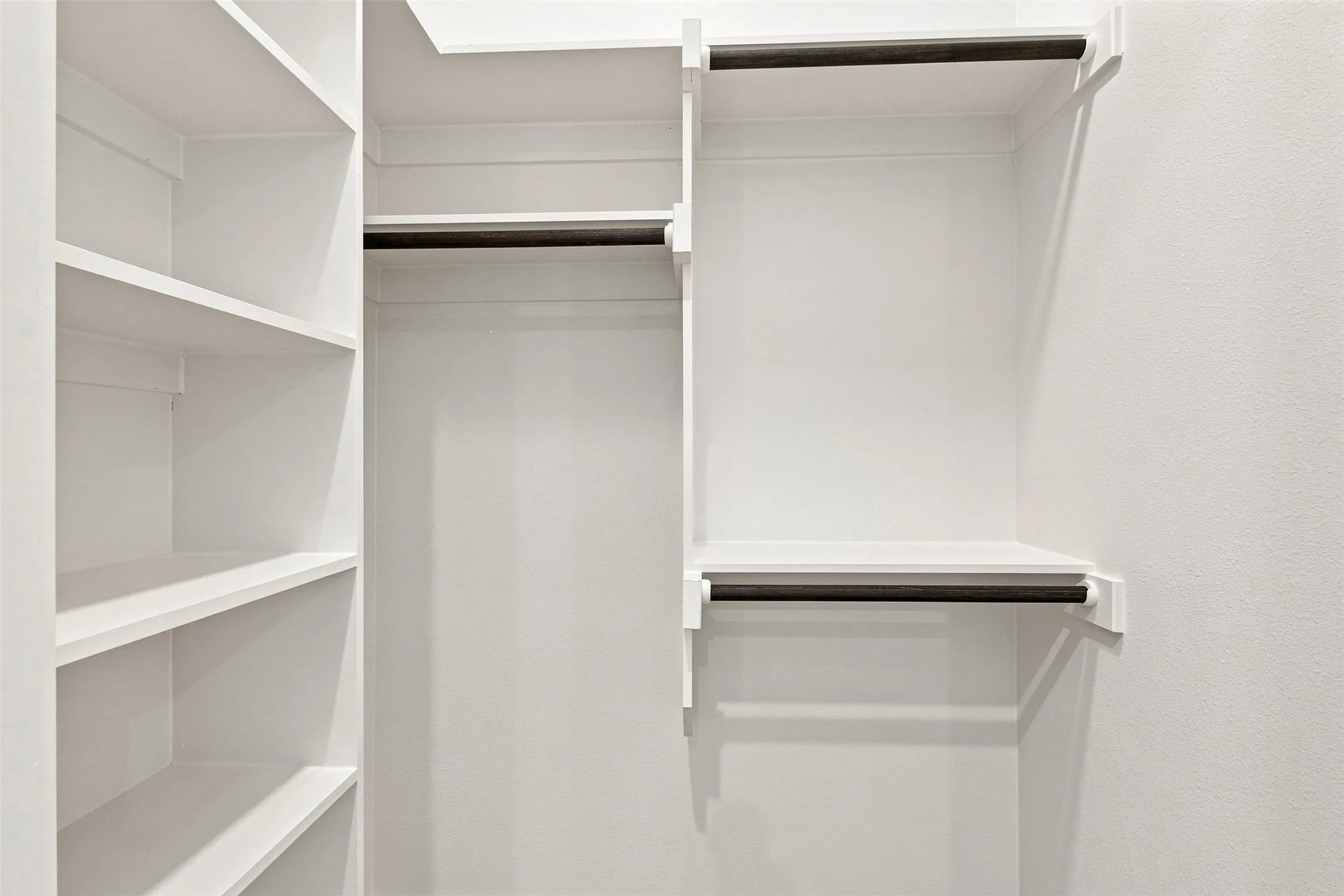 Built-in shelving and hanging rods with a white finish