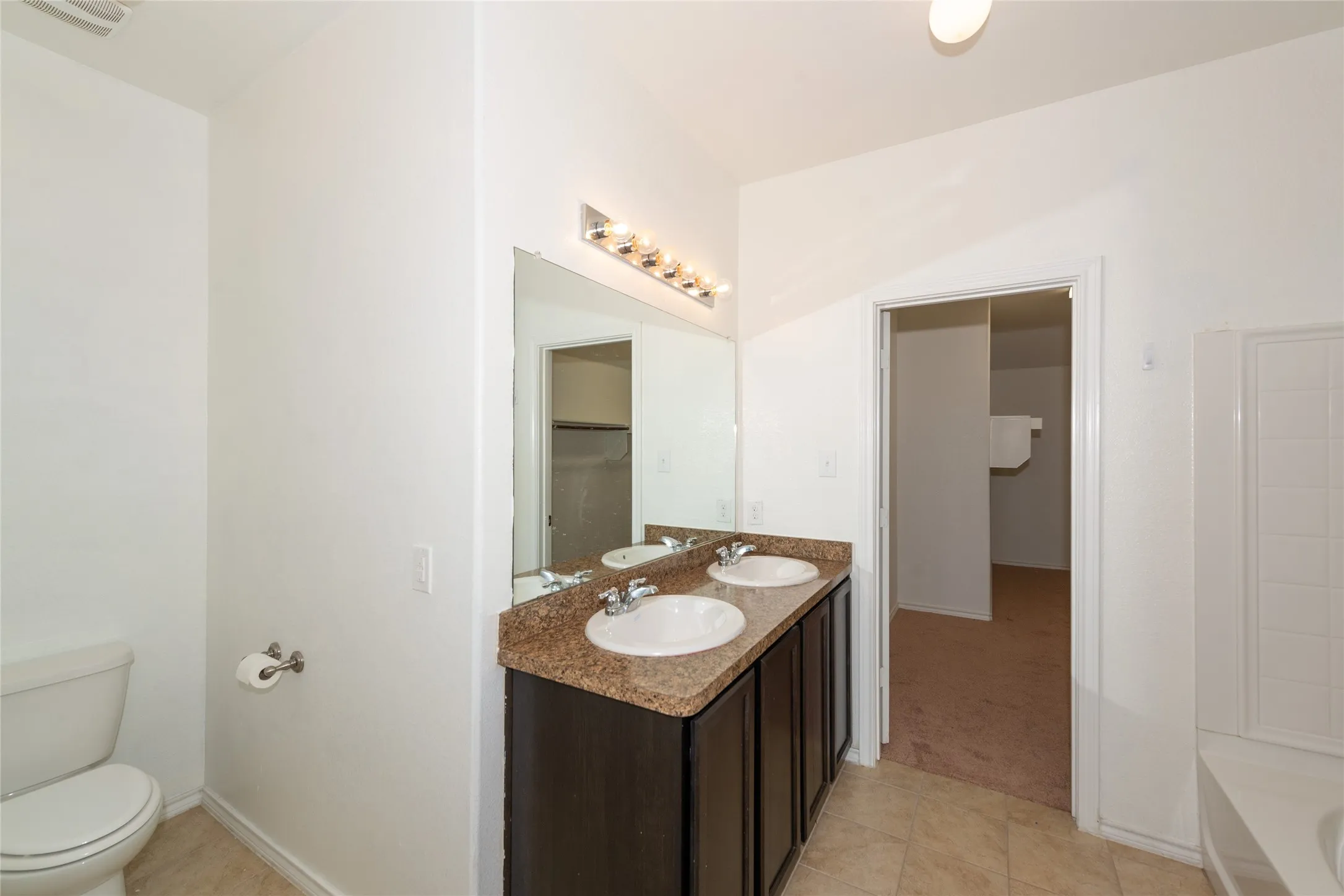 Dual vanity with undermount sinks and a stone-finish countertop