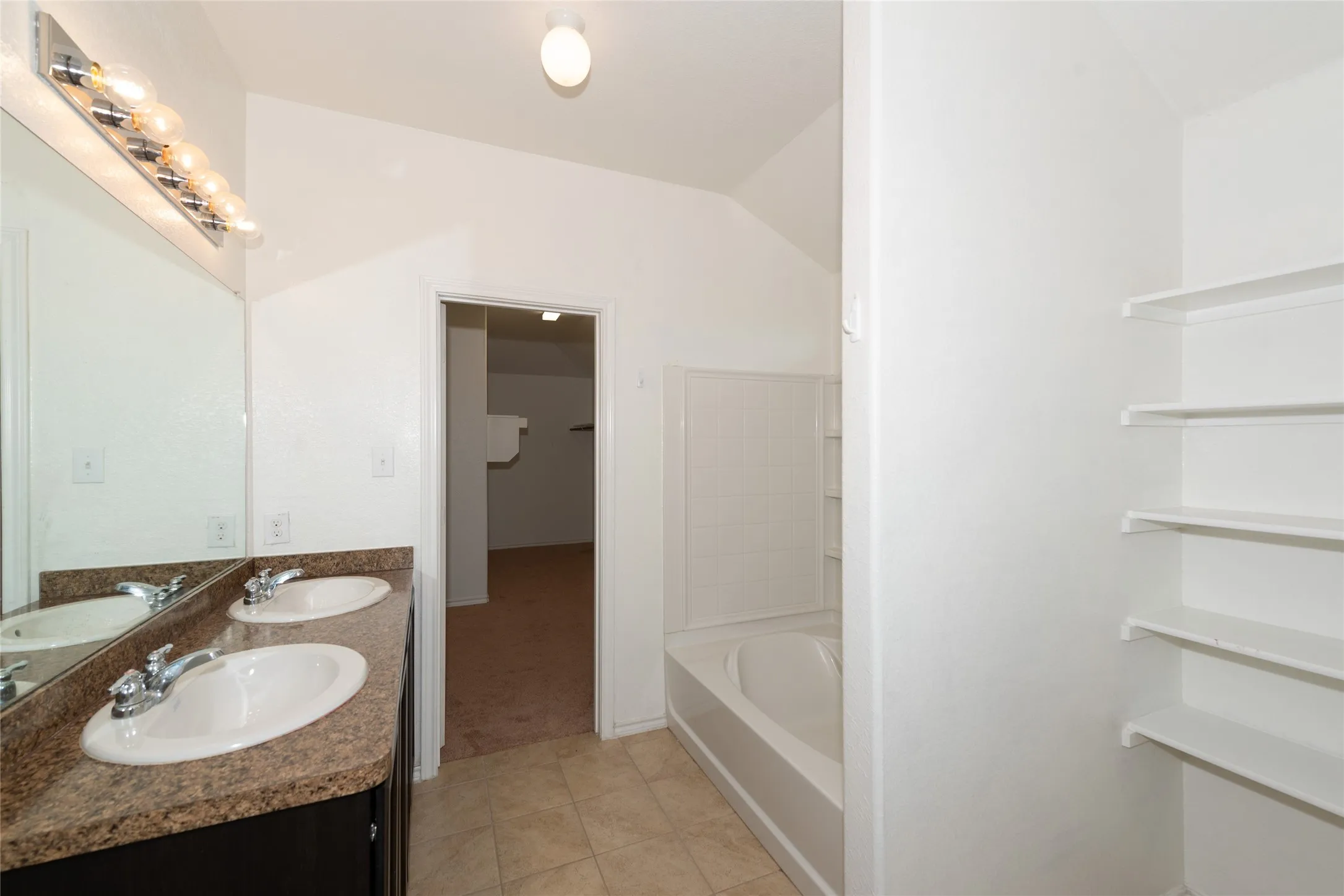 Dual vanity with integrated sinks and a stone-finish countertop