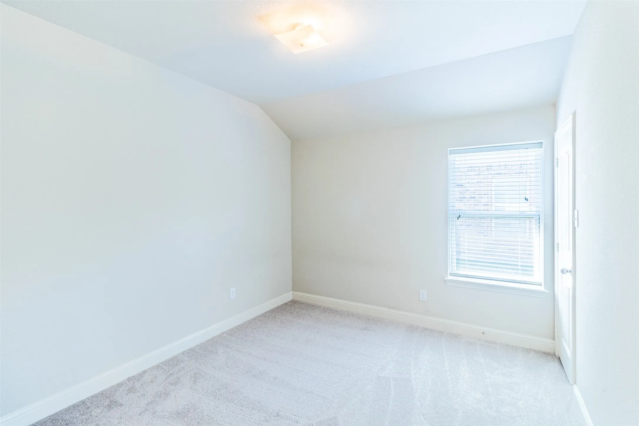 bedroom#2 Carpeted flooring, window with blinds, ceiling-mounted light fixture, white walls, and a white door