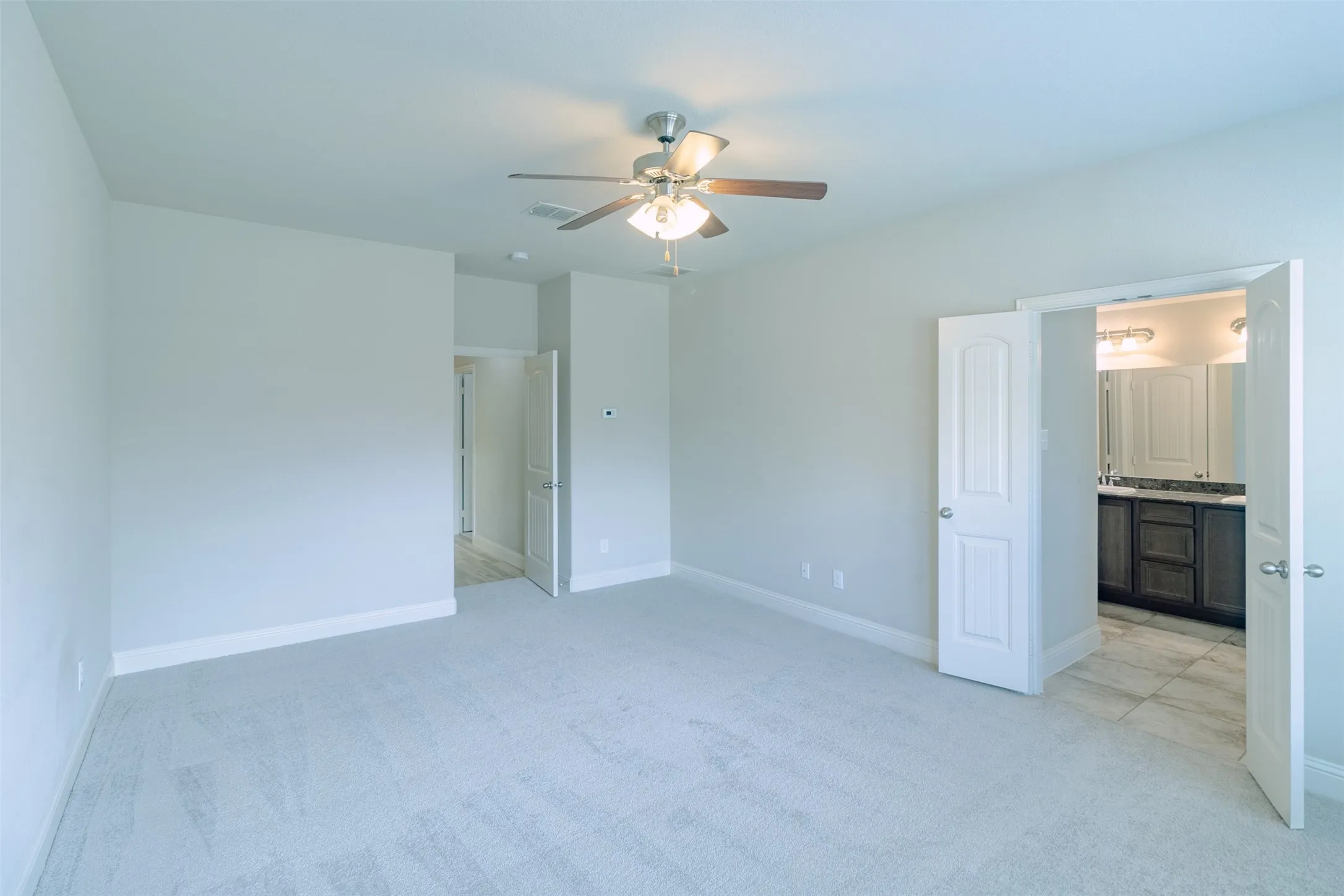Recessed lighting, ceiling fan, plush carpet flooring, two-panel interior doors, and tile flooring