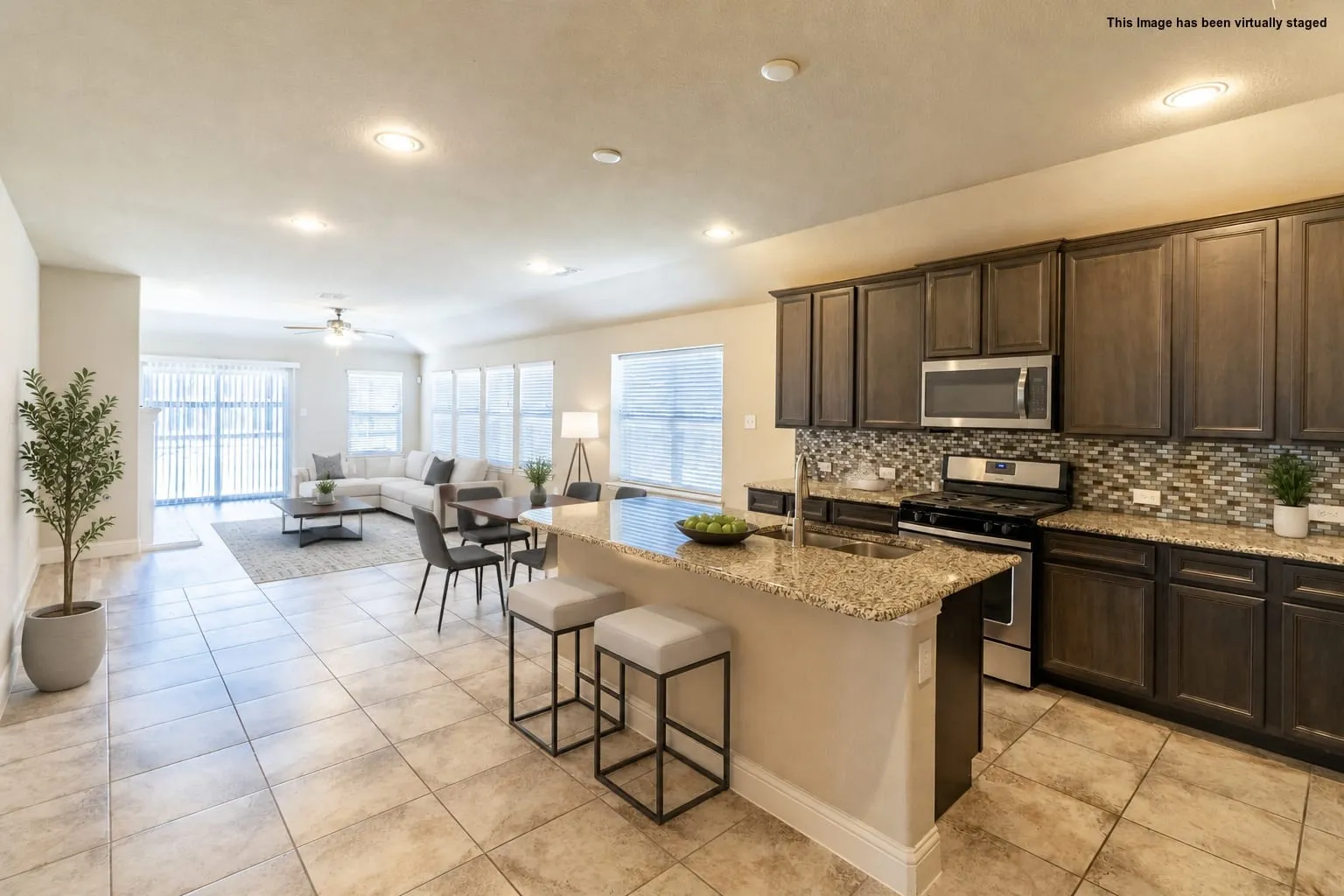 Virtual staged=>Open-concept living area with tile flooring and recessed lighting
