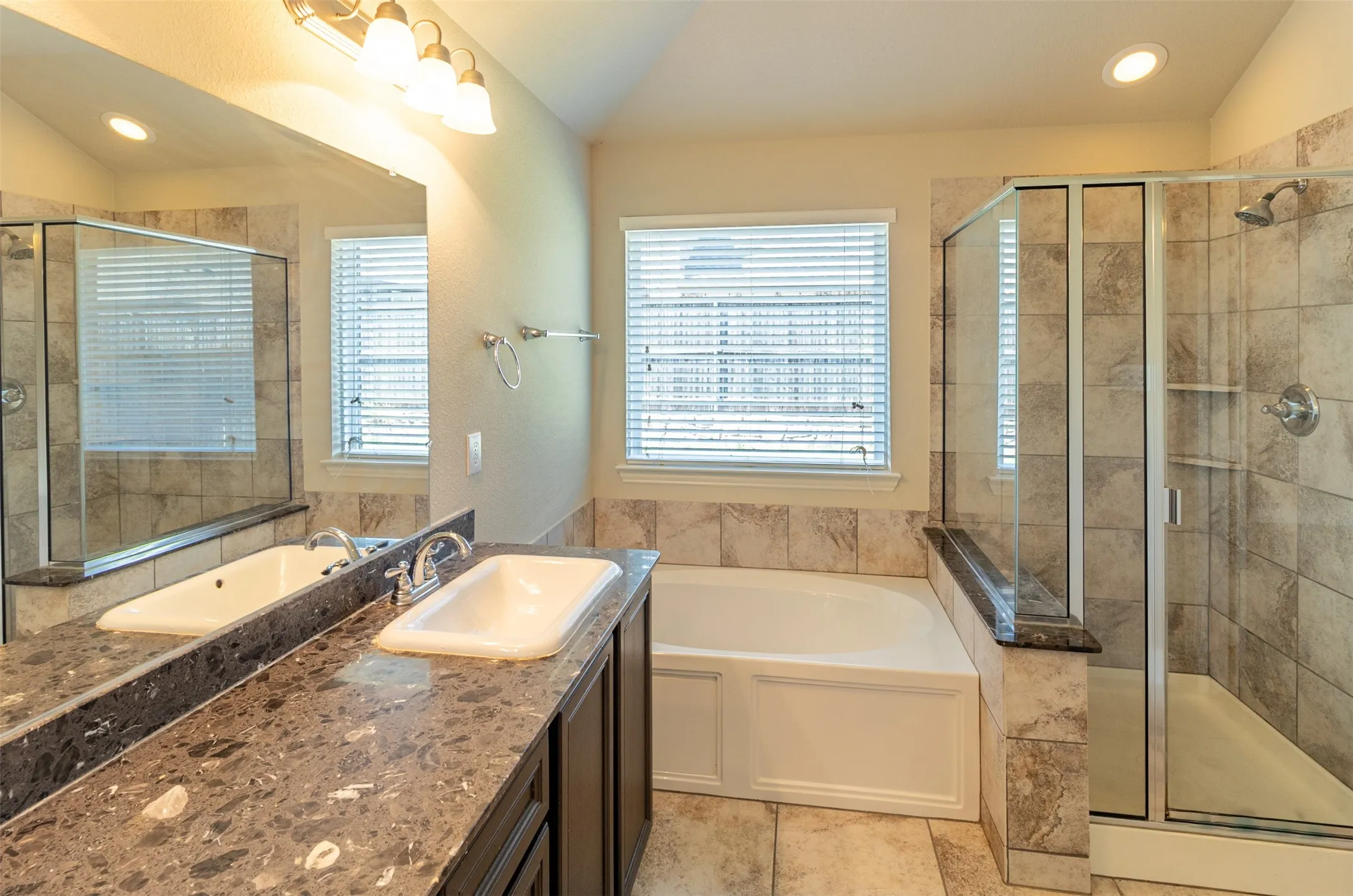 Dual vanity with integrated sinks and dark stone-finish countertops