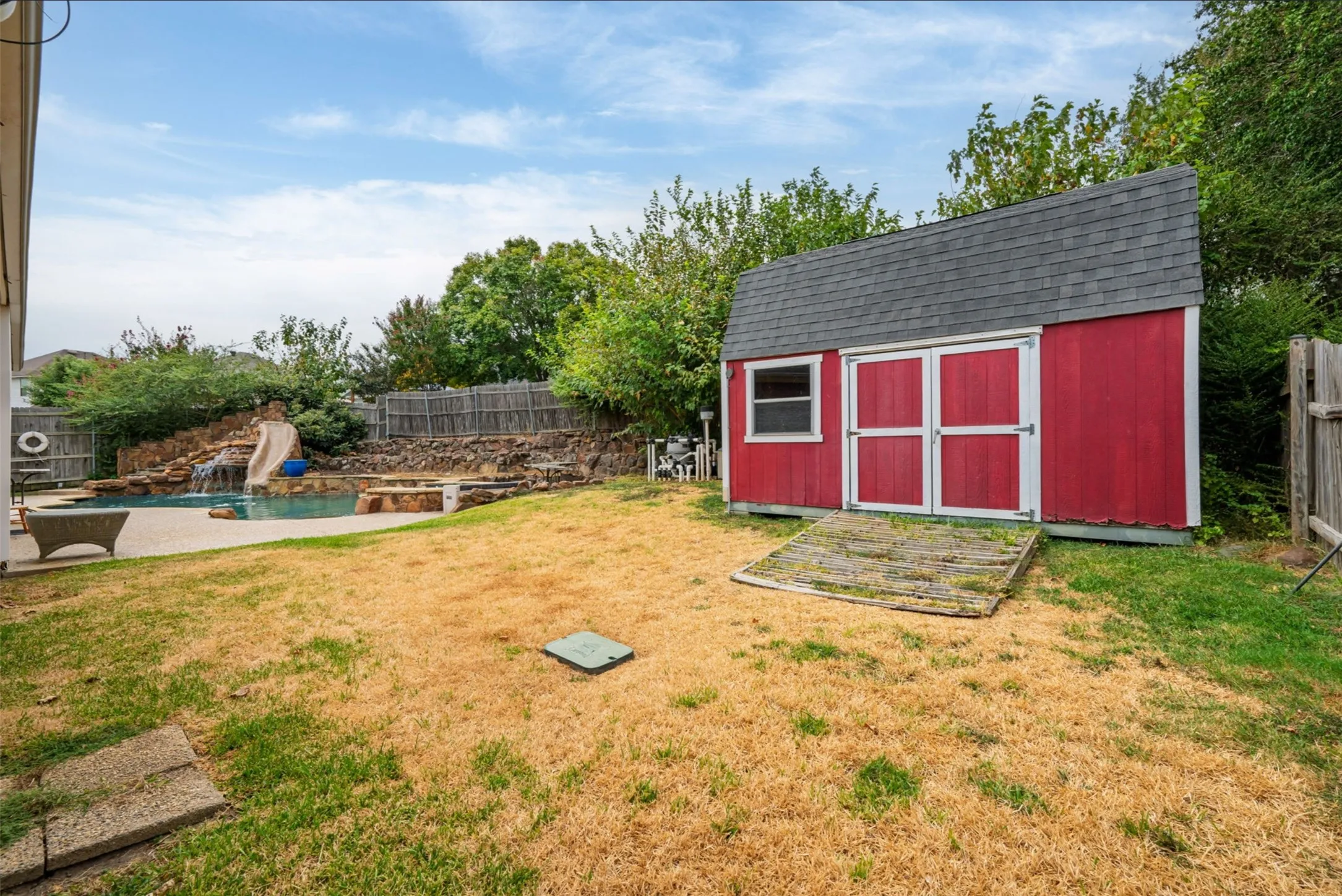 Backyard storage can be upgraded to pool changing room, she-shed, man cave or woodshop. Electrical access just outside the door.