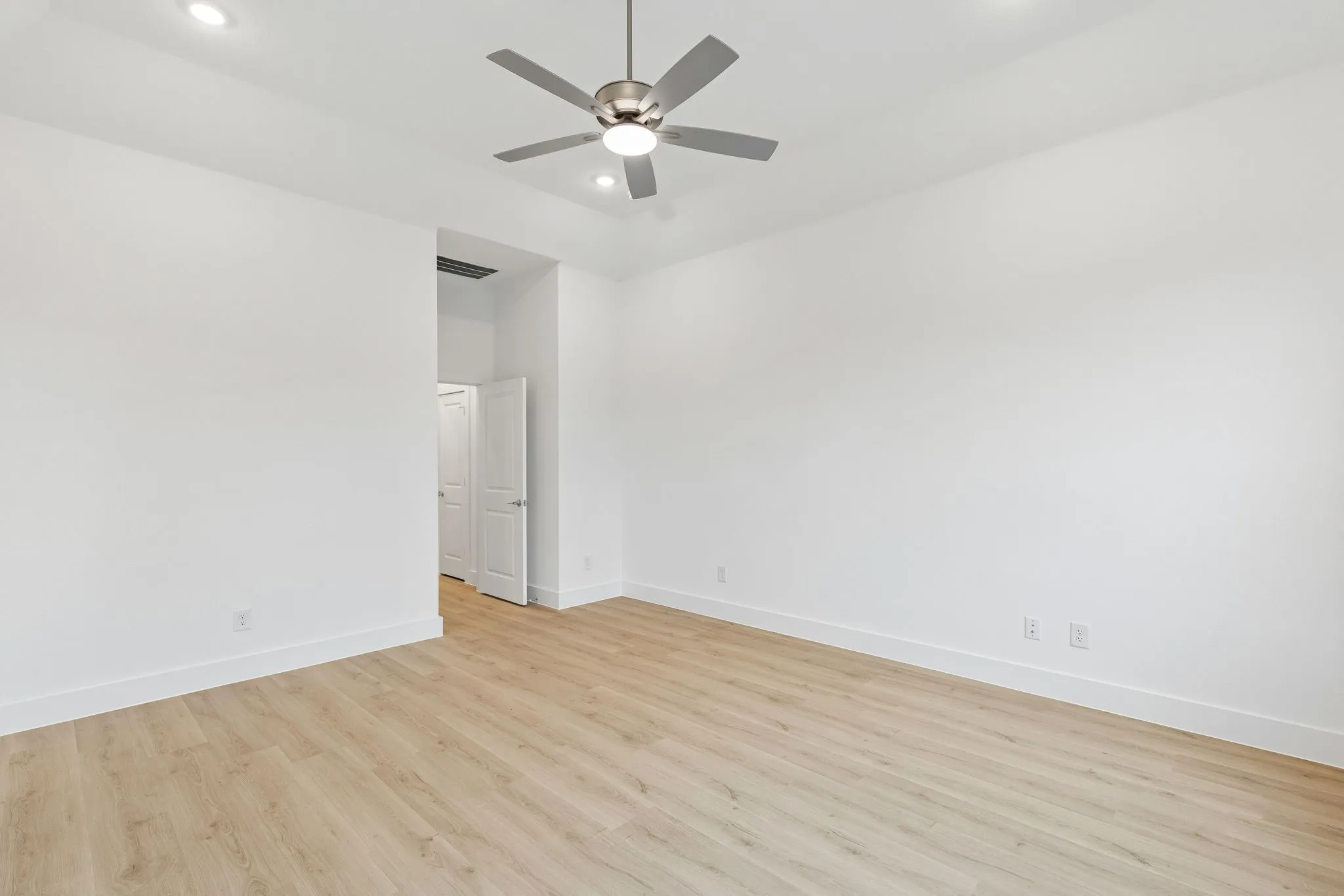 Recessed lighting, ceiling fan with integrated light, light wood-finish flooring, and white walls