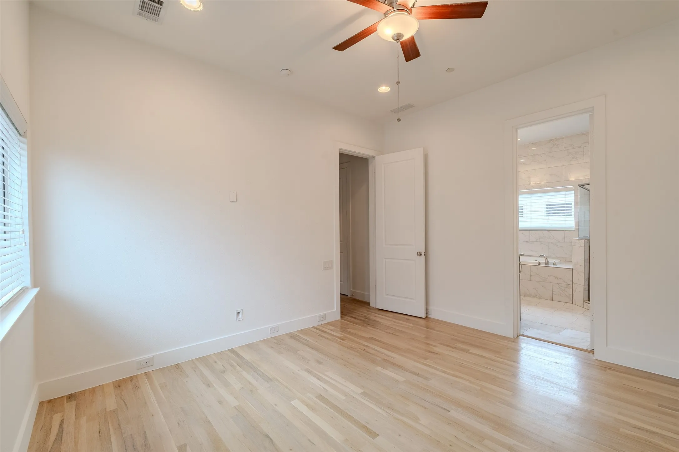 Hardwood flooring, ceiling fan with integrated lighting, recessed lighting, white window blinds, and white interior doors