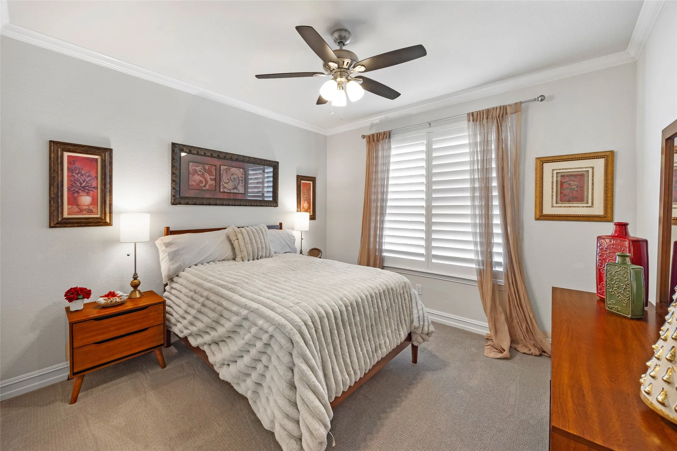 Wall-to-wall carpeting, crown molding, and a ceiling fan with integrated lighting